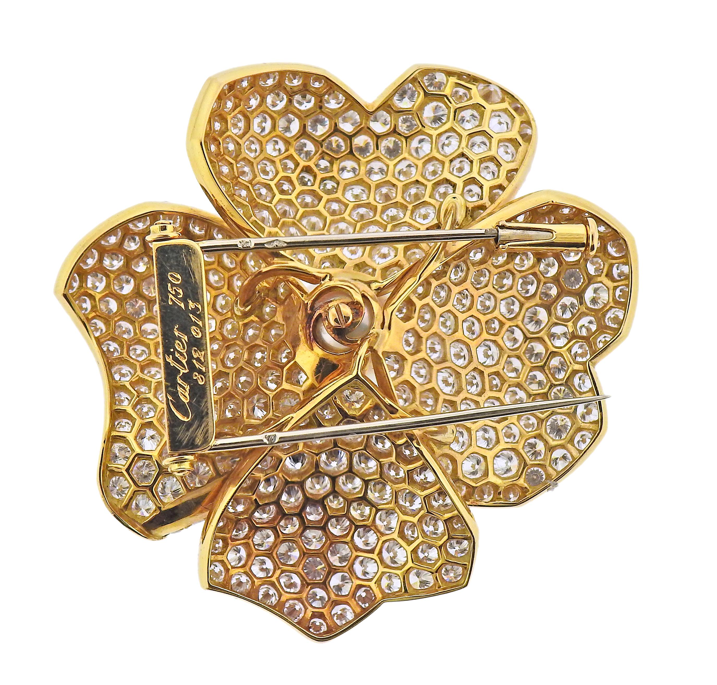 Impressive 18k gold flower brooch by Cartier, set with approx. 15 carats in diamonds and a 10mm South Sea pearl. Brooch measures 46mm x 45mm. Marked: Cartier, 750, 812 013. Weight - 23.1 grams.