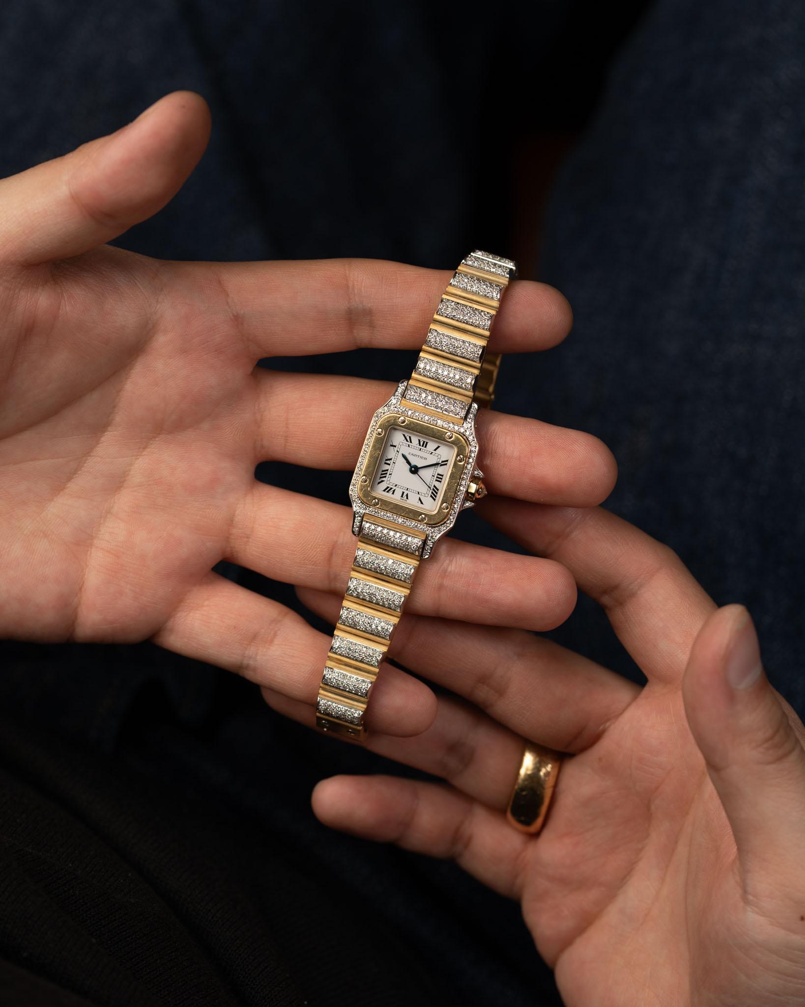 Cartier Special Order Santos Carrée Factory Pave Diamonds Deux Or 18k WG/YG 1980s
SKU: 1699

A rare and exceptional example of Cartier’s artistry from the 1980s, this Special Order Santos Carrée SM (Ref. 170916) features a white dial encased in a