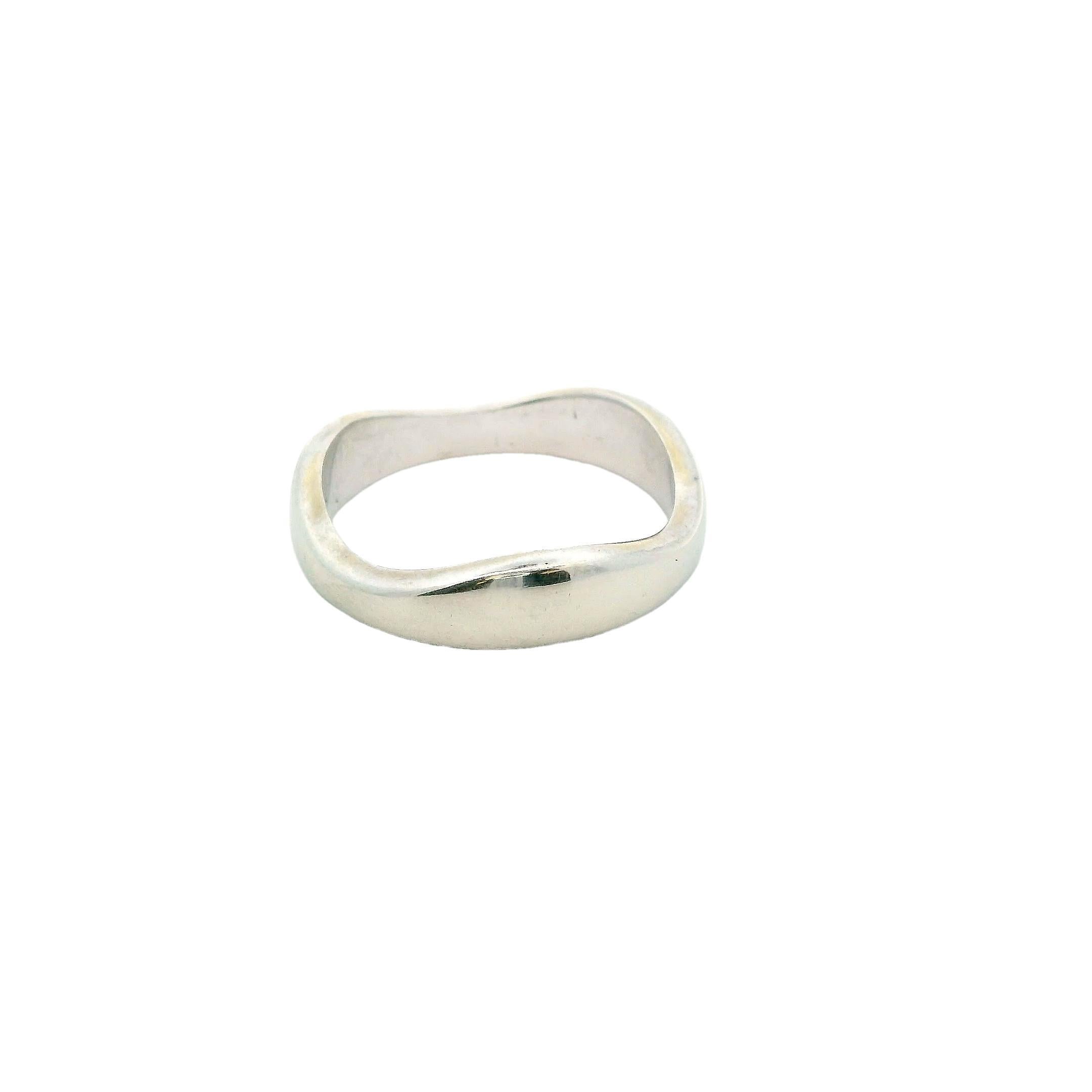 A study in form and subtlety.

This unique Cartier ring showcases a sleek, modern design with a gently contoured band. Crafted in lustrous 18k white gold, its smooth, polished surface reflects light with understated elegance. The band’s soft, square