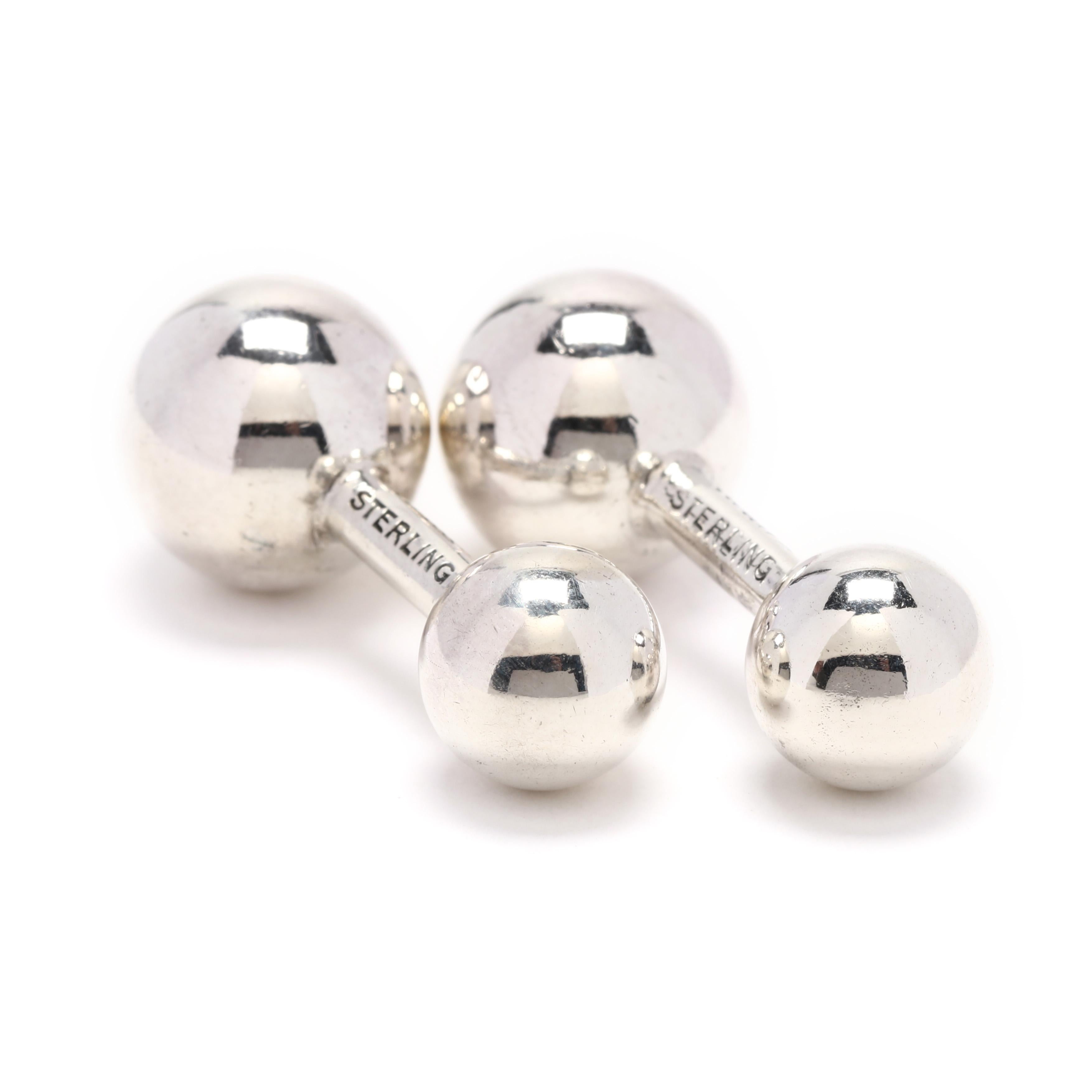 A pair of sterling silver Cartier dumbbell cufflinks. These cufflinks feature a large polished sphere at one end and a smaller sphere at the other end.



Length: 1 3/16 in.



Width: 1/2 in.



Weight: 7.9 grams