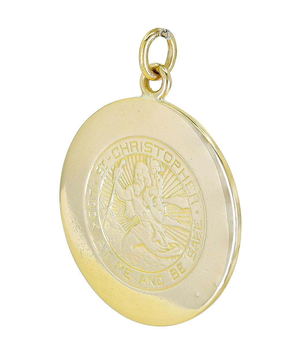 Rare Cartier New York Large St. Christopher medal.  Iconic image of St. Christopher holding a child in foreground, background of radiating line pattern bordered by phrase 