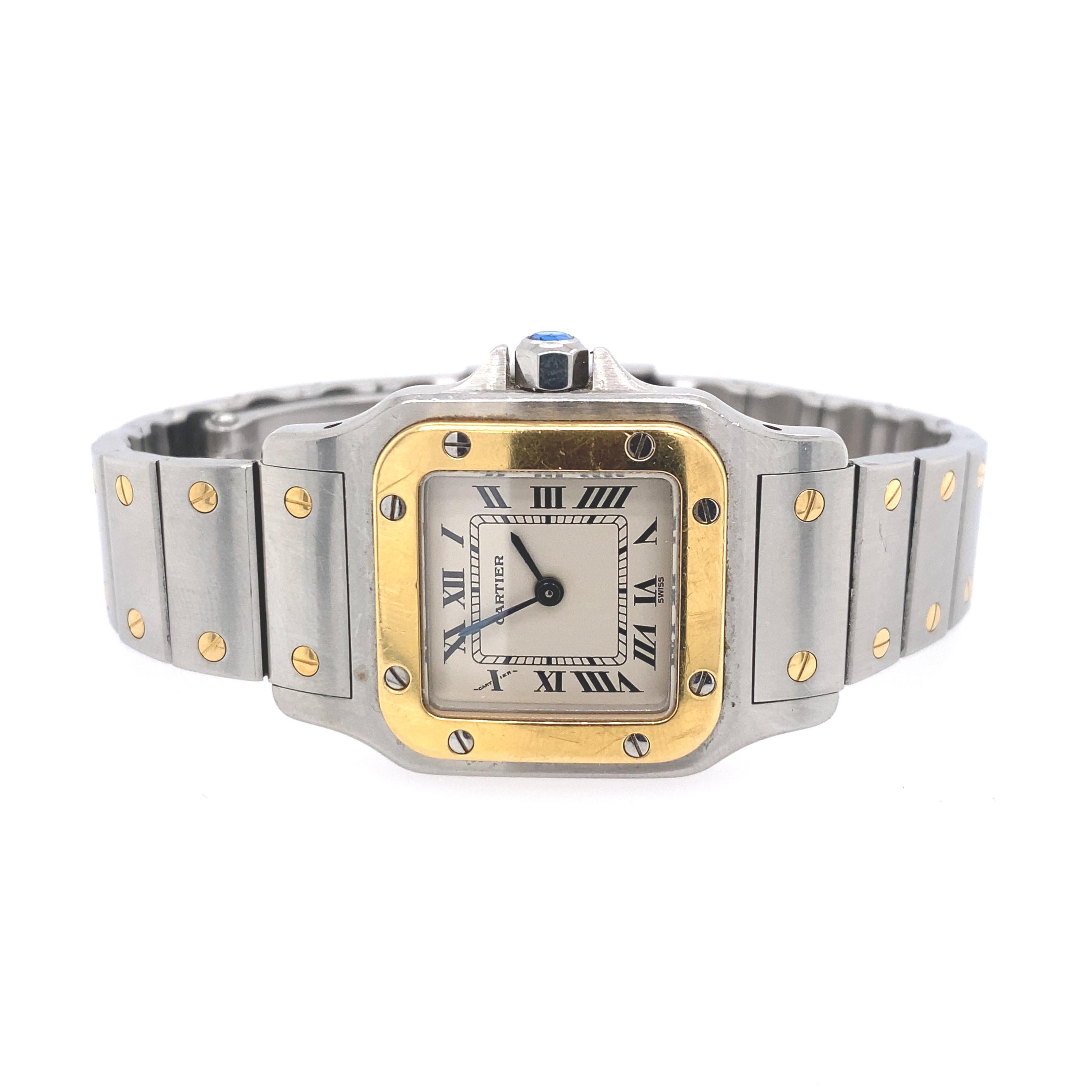 Cartier Stainless Steel and Gold 'Santos' Wristwatch
18 kt., quartz, square off-white dial, black Roman numerals, blued steel hands, cushion-shaped screw-down gold bezel, round synthetic blue spinel crown, dia. ap. 23.5 mm., tapered bar link steel