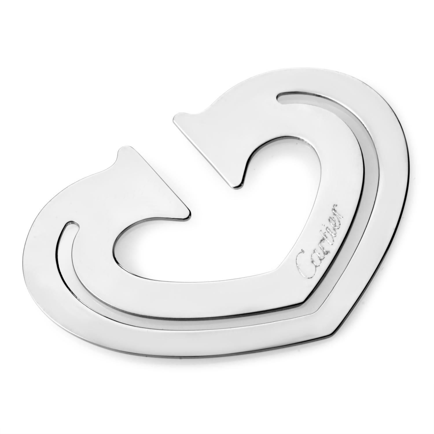 A creatively glamorous addition to one's lifestyle, this Cartier bookmark shaped like a heart is a stainless steel gem.