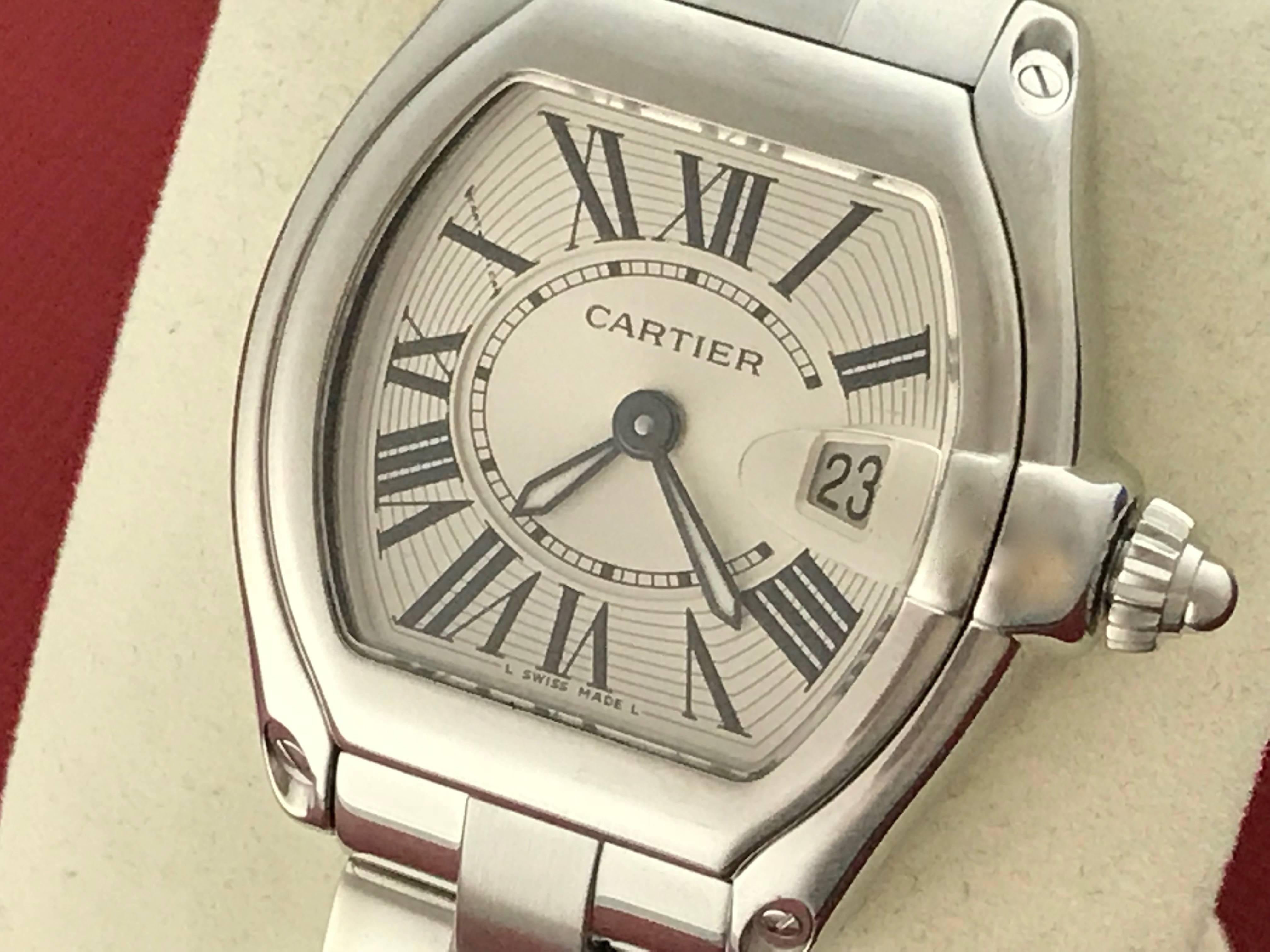 Cartier Roadster Model W62016V3 Ladies Quartz with Date wrist watch. Stainless Steel rectangular tonneau style case (30x35mm), Stainless Steel Catier bracelet with deployant clasp. Silver Dial with black Roman numerals. Certified Pre Owned and ready