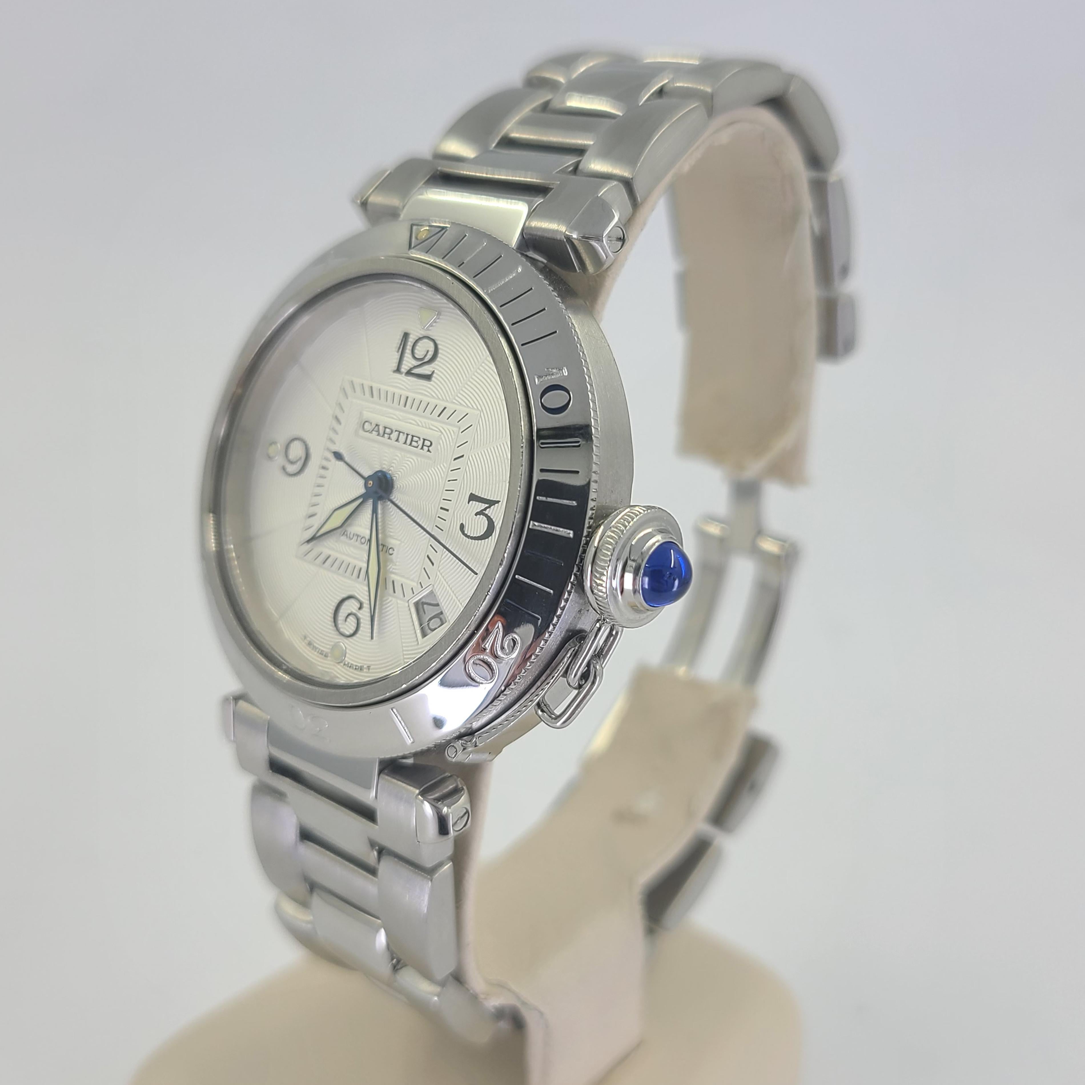Pre-Owned Cartier Pasha 38mm Stainless Steel Automatic Watch Featuring Unidirectional Rotating Bezel and Date Function On Steel Bracelet. Sapphire Caseback Allows For Viewing of the Movement Rotor. Caseback Bezel Engraved 2378. Includes 1 year