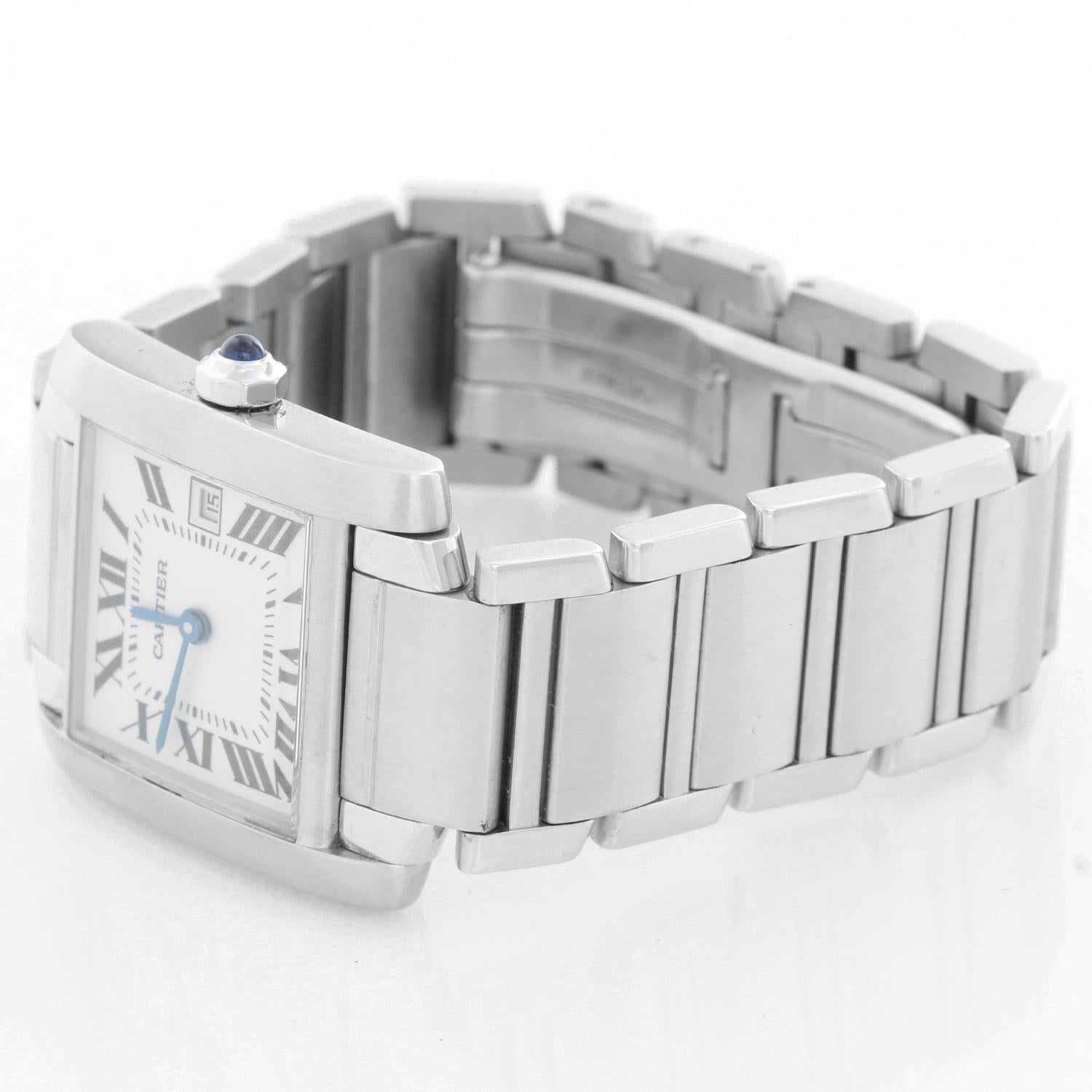 Cartier stainless steel Tank Francaise midsize wristwatch, Ref. W51011Q3, with quartz movement. Stainless steel case (25mm x 30mm). Ivory-colored dial with black Roman numerals, date at 3 o'clock. Stainless steel Cartier bracelet with deployant