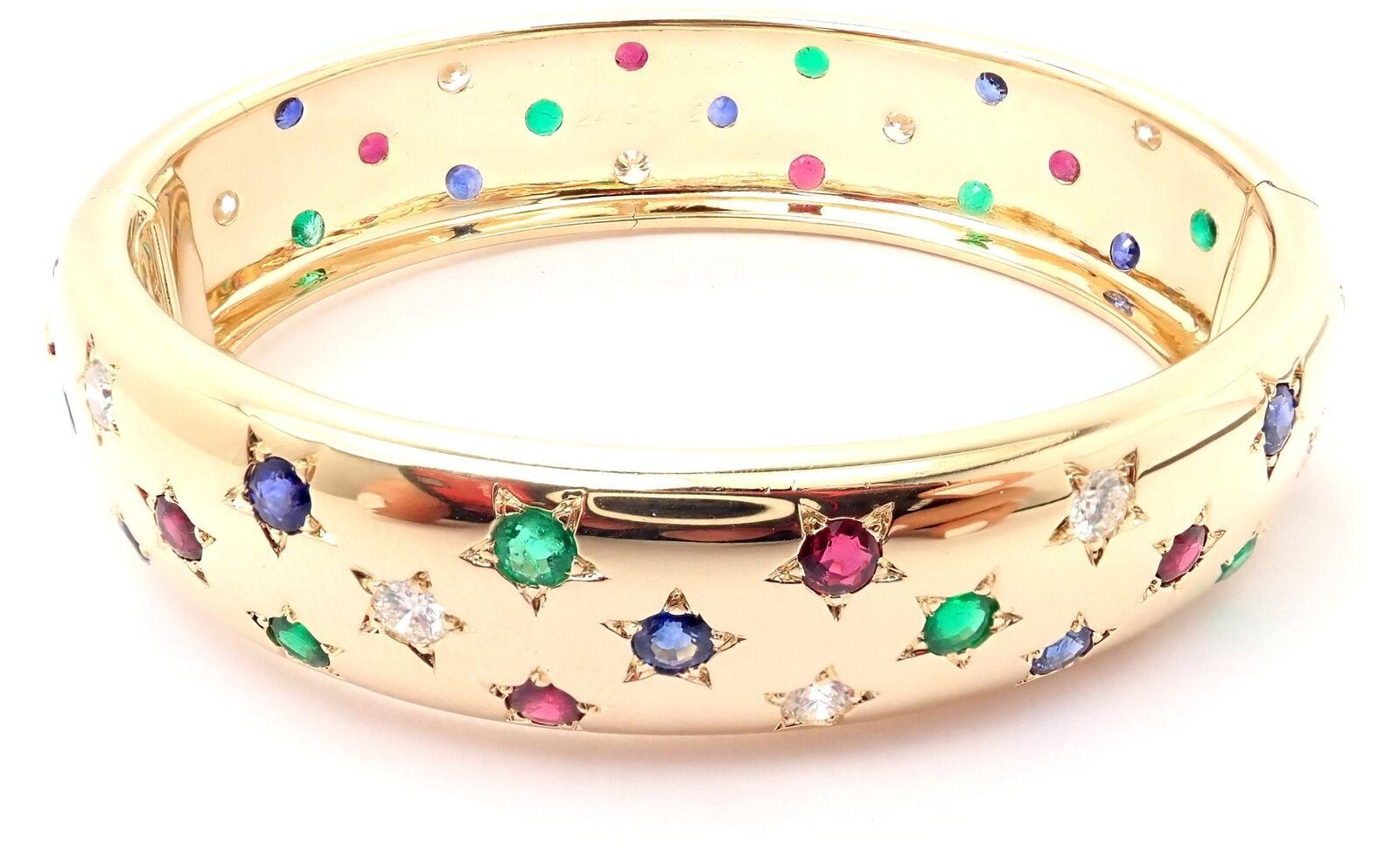 18k Yellow Gold Diamond Sapphire Emerald Ruby Bangle Bracelet by Cartier.
With round brilliant cut diamonds VVS1 clarity, F-H color Round rubies, emeralds and sapphires
This bracelet comes with Cartier box and certificate of