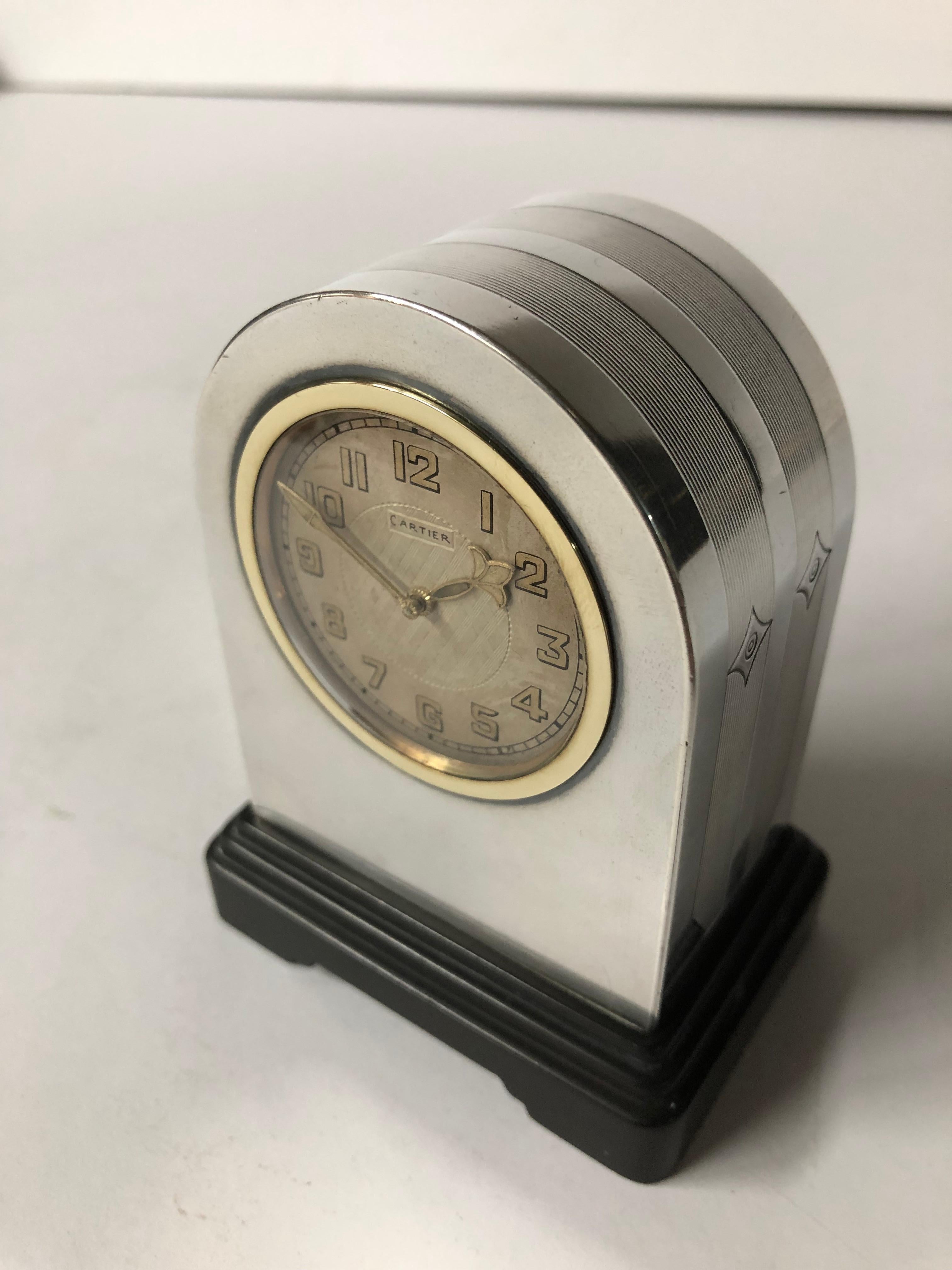 1930s Cartier sterling silver desk clock
-European Watch Co movement
-18-karat gold bezel
-Onyx base
-Includes key.

Hallmarked 
