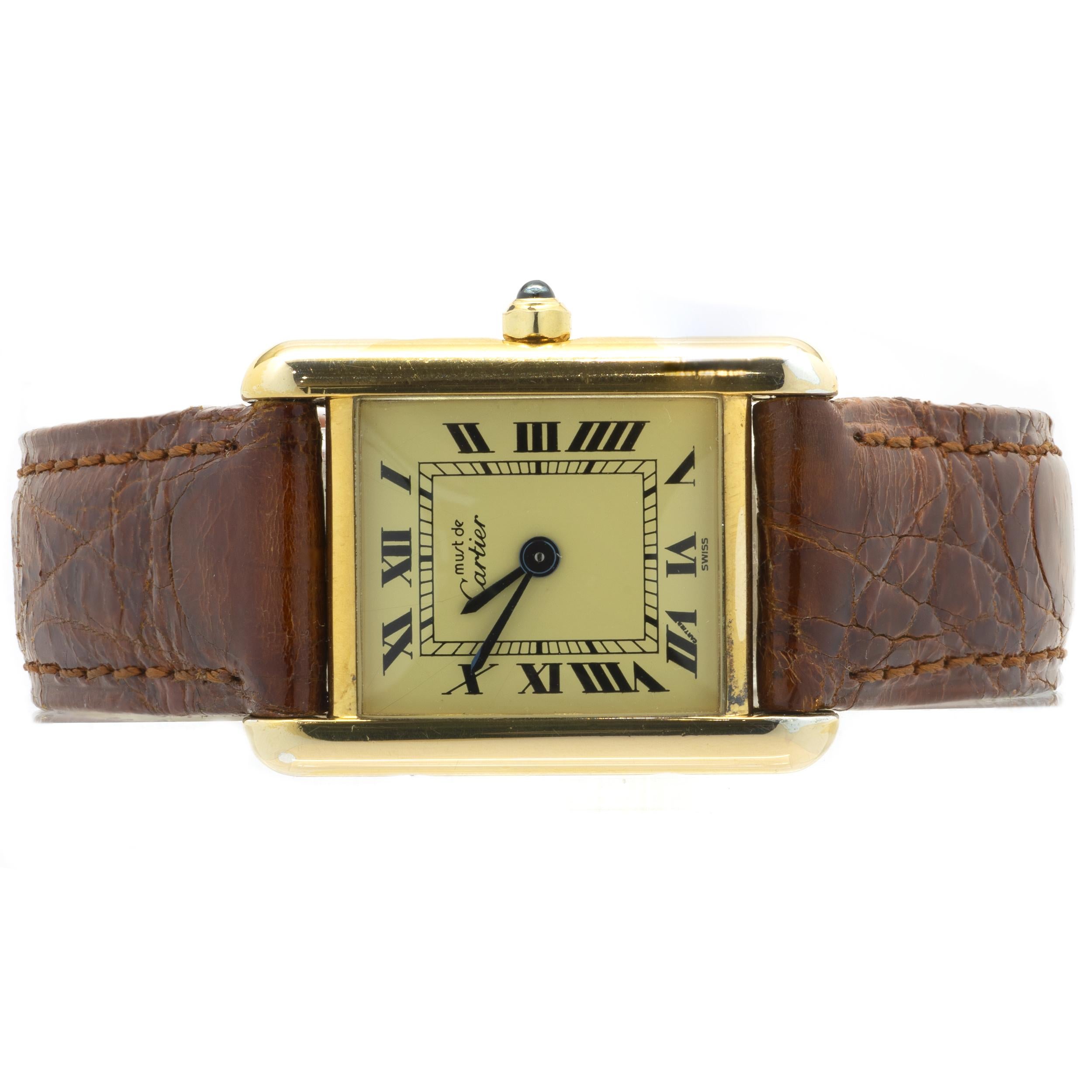 Movement: automatic
Function: hours, minutes
Case: 23.4 X 30.6mm gold vermeil sterling silver rectangle case, push pull crown, sapphire crystal, 
Dial: cream roman dial, blue sword sweeping hands
Band: brown crocodile Cartier strap, gold vermeil