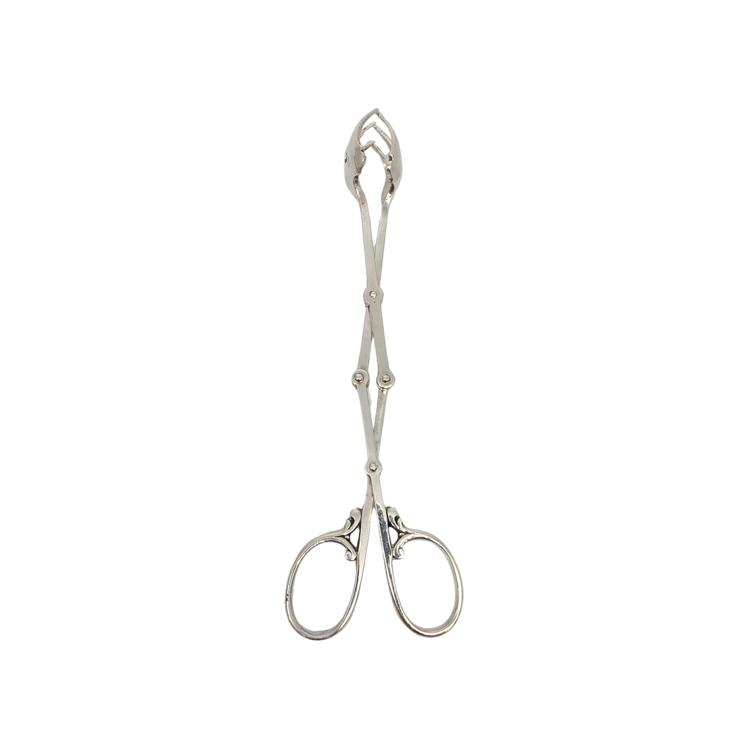 Cartier sterling silver ice tongs.

No monogram

Accordion scissor style ice tongs featuring 3 fork-like tines on each arm.

Measures approx 7 1/2