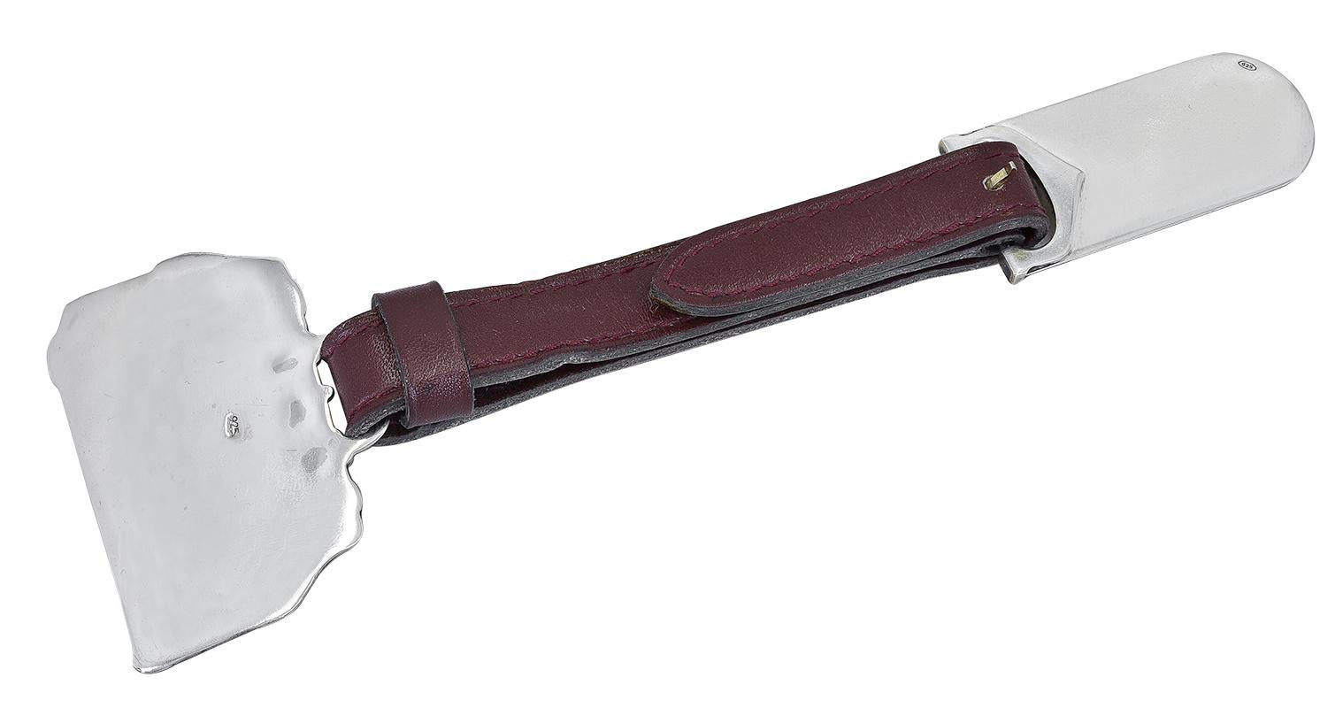 Priority boarding!  Cartier New York Sterling Silver luggage tag; figural luggage bag attached to bordeaux leather strap with pin and buckle.  Iconic figural 
