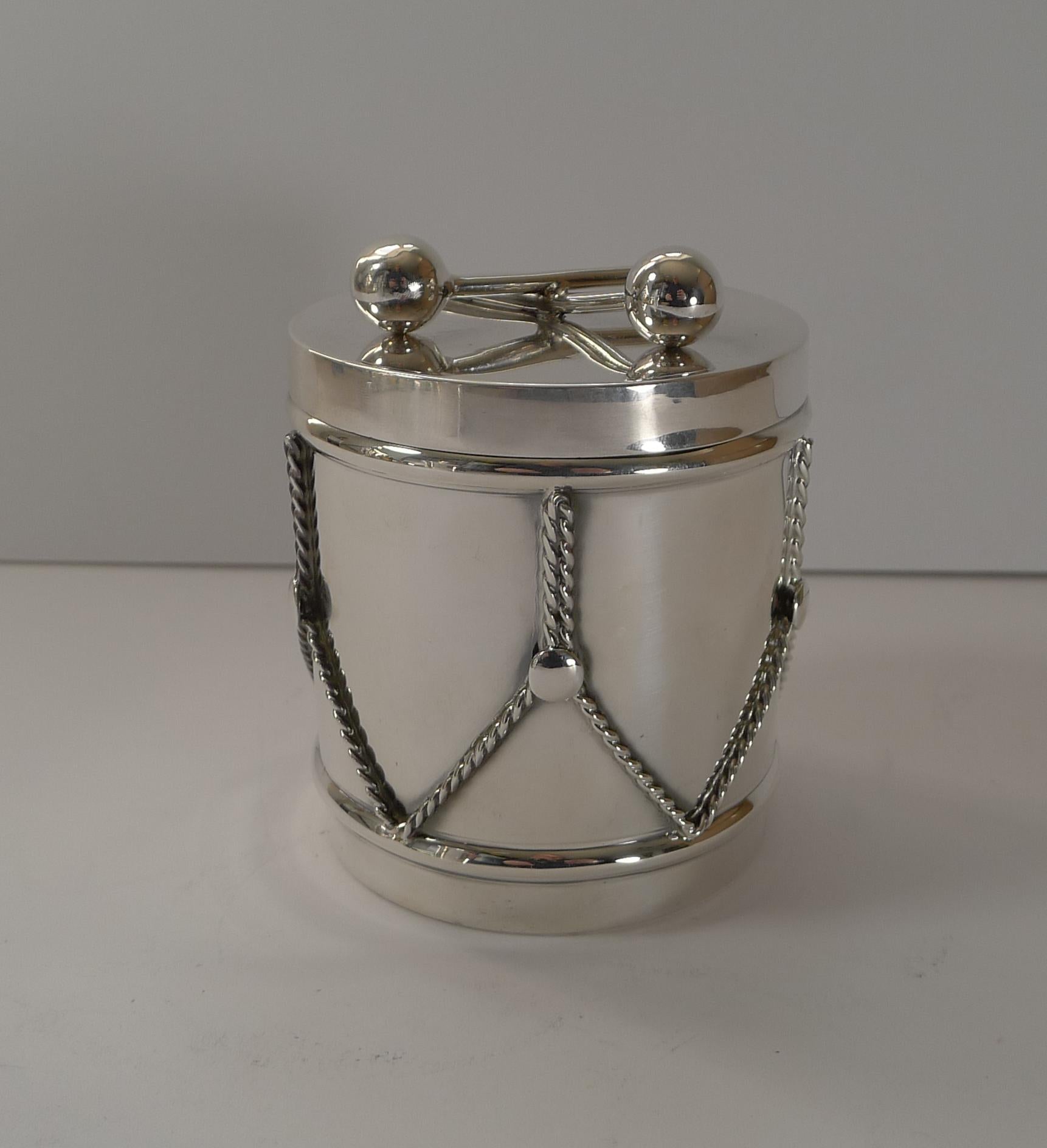 An exquisite and unusual sterling silver box in the from of a drum with a glass liner inside.

Marked on the underside by the famous silversmith / Jeweller, Cartier and marked Sterling.

Excellent condition dating to c.1970 measuring 3 1/2