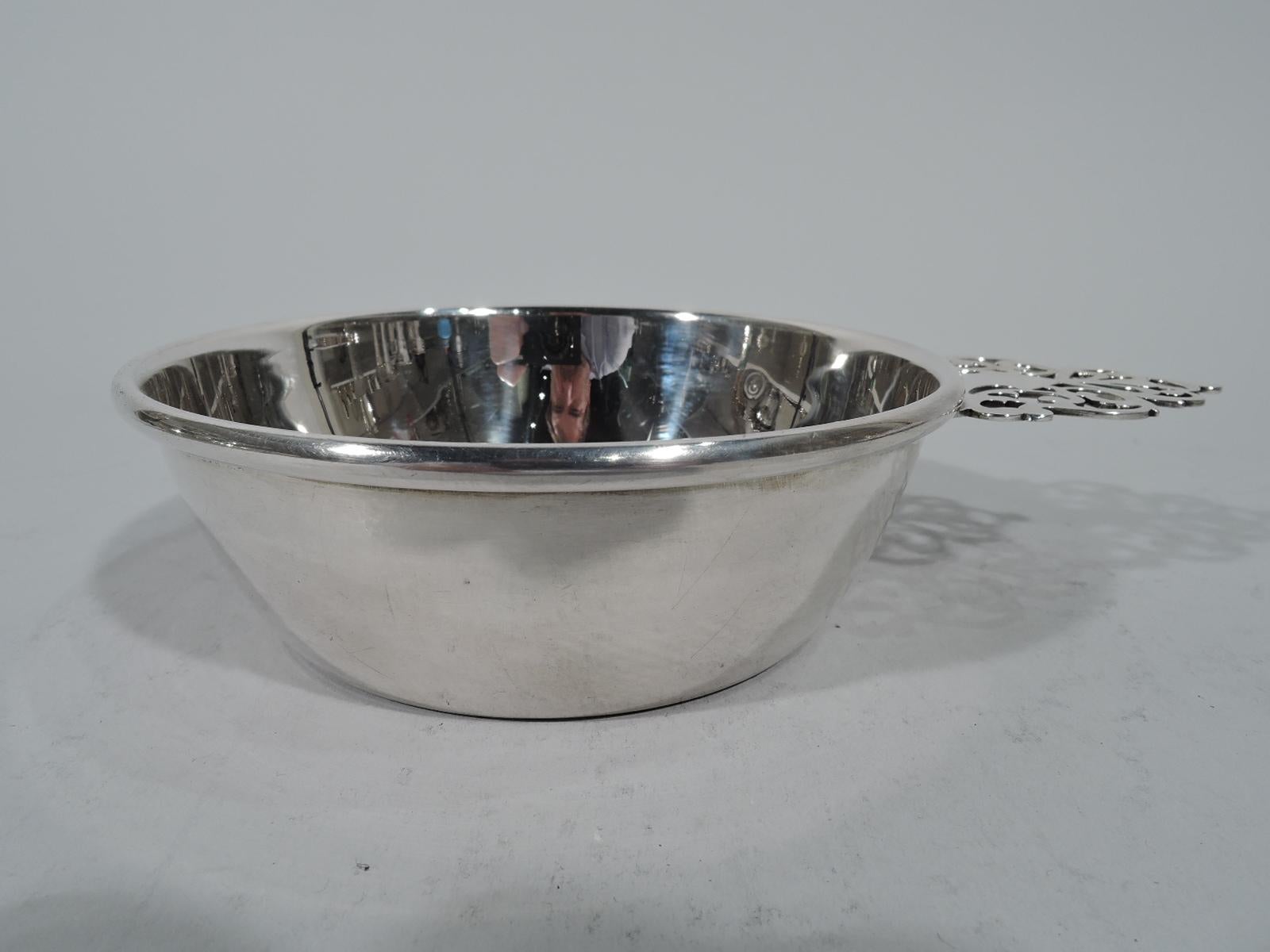 Traditional sterling silver porringer. Retailed by Cartier in New York. Tapering sides and open tree handle. Fully marked with maker’s (Baldwin & Miller) and retailer’s stamps and no. D60. Weight: 4.7 troy ounces.