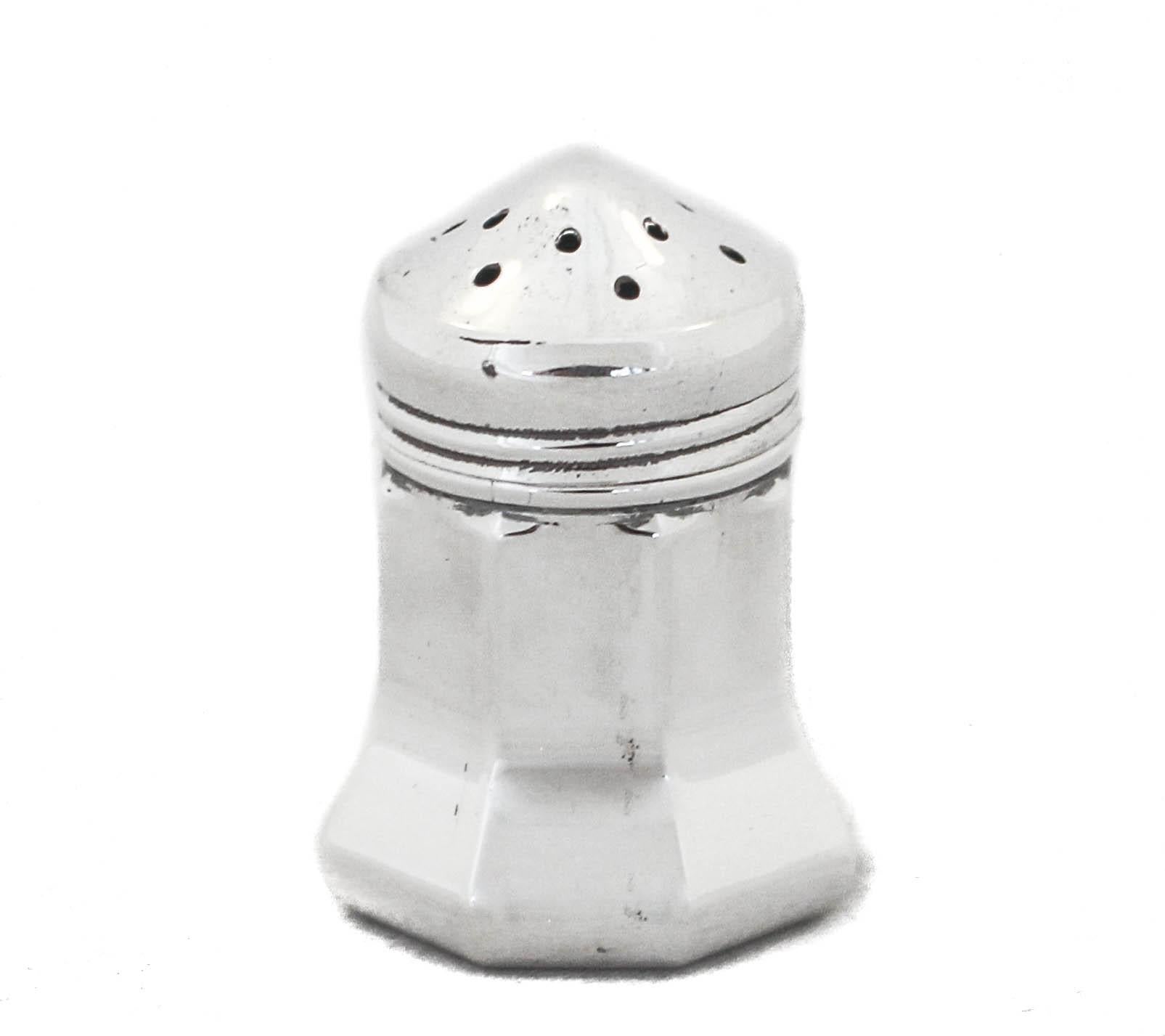 Being offered is a set of eight sterling silver salt shakers made by Cartier.  Each of the eight individual shakers fits into a slot in the original Cartier box (the box is in very good condition).  They have a MidCentury modern shape and look and