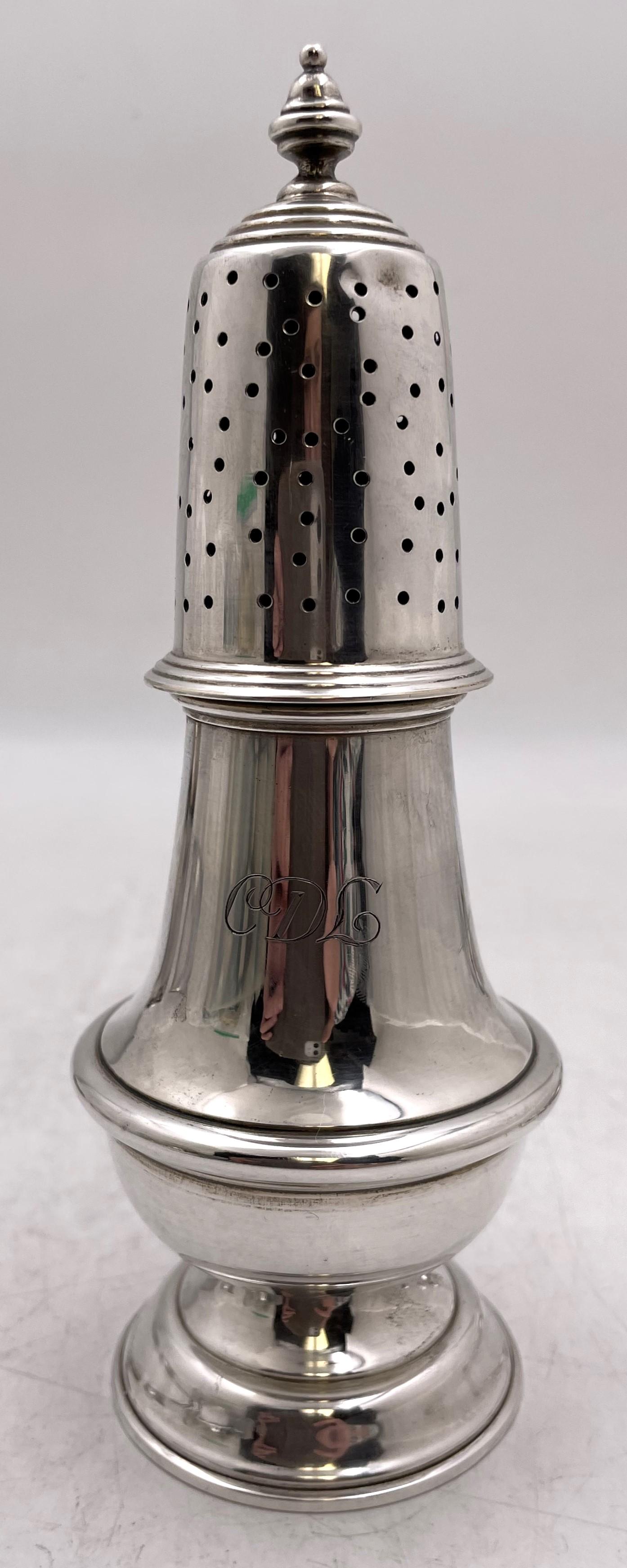 Cartier sterling silver sugar shaker or muffineer from the 20th century. As marked on the base, it is a reproduction of a design by Paul Revere. It measures 7 1/3'' in height by 2 1/4'' in diameter at the base, weighs 3.9 troy ounces, and bears