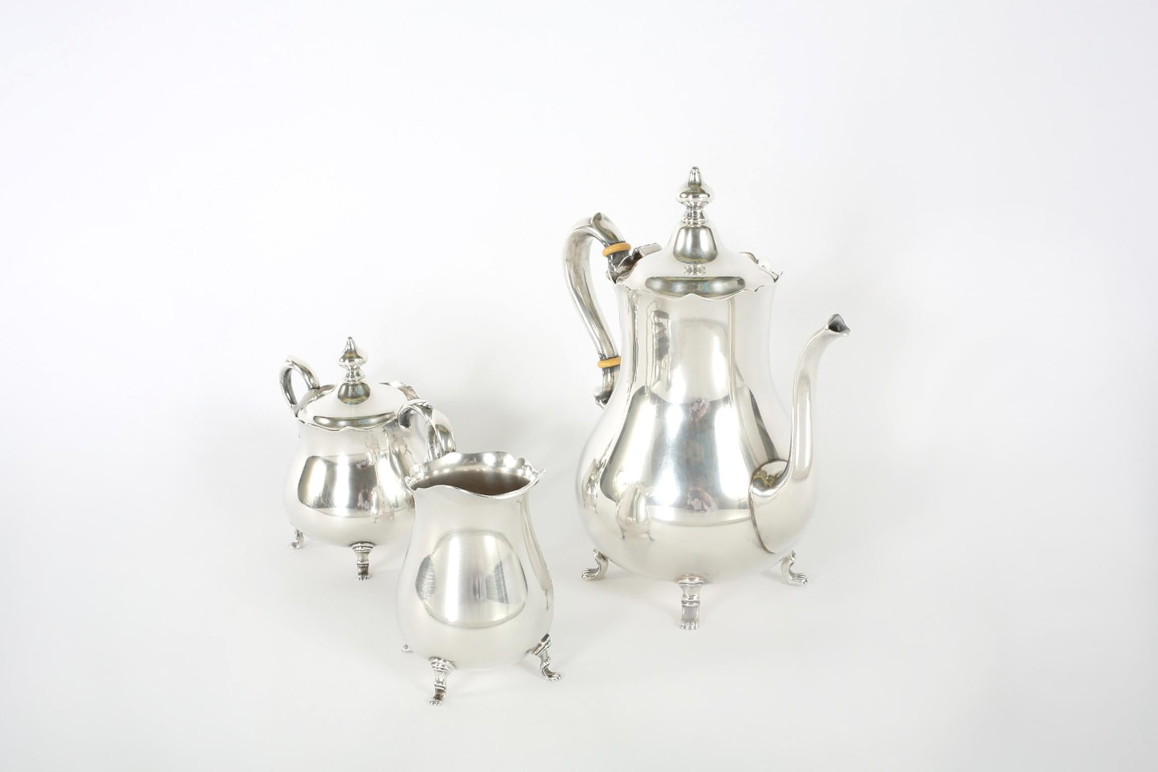 Mid-20th century Cartier sterling silver three-piece tea / coffee service with paw feet details. Each piece is in great vintage condition with wear appropriate to age / use. Maker's mark undersigned. Measures: Tea / coffee pot is about 9