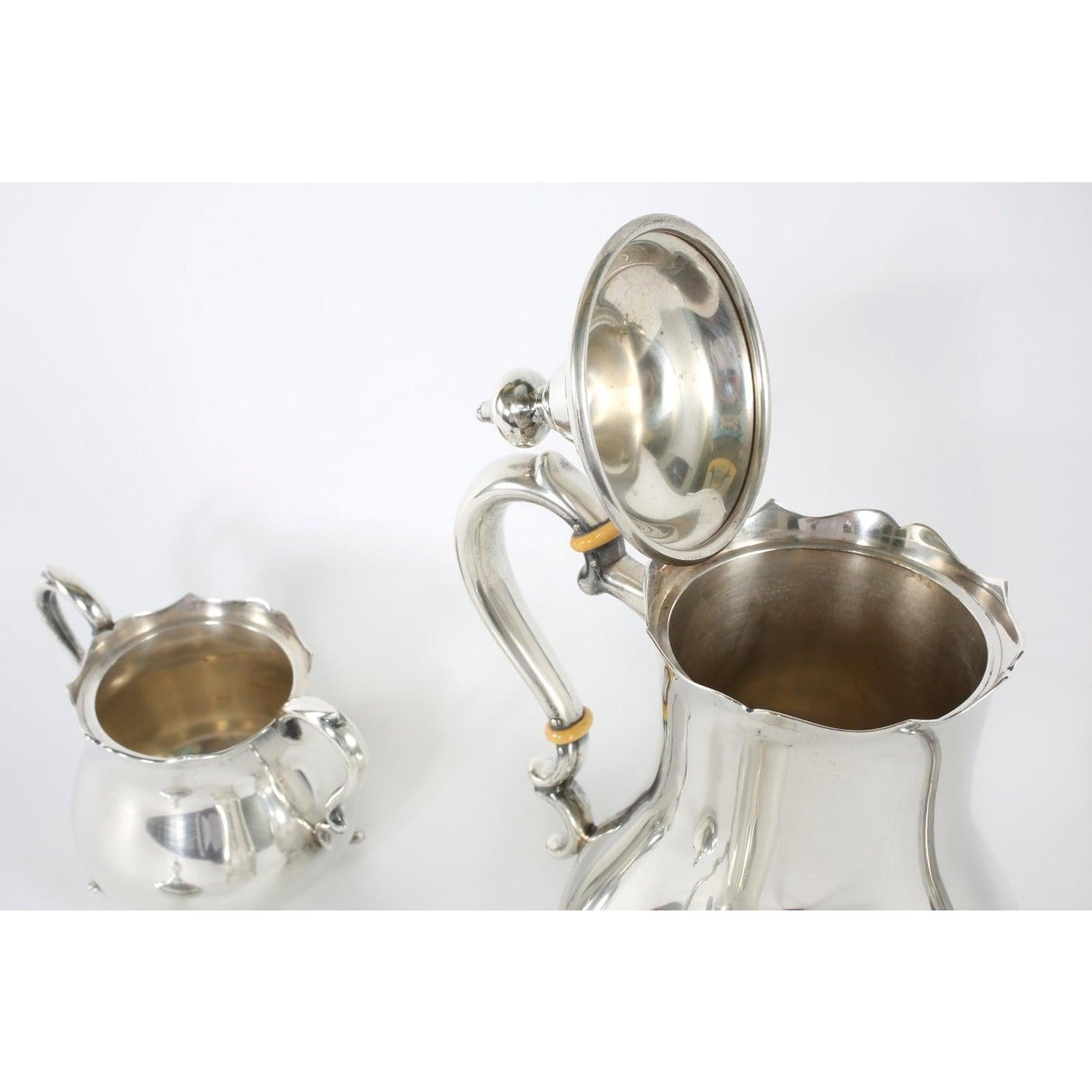 Cartier sterling silver tableware coffee / tea three piece service. The piece features a very clean line design with paw feet details. Each piece is in great vintage condition with minor wear consistent with age / use. Maker's mark undersigned. Tea