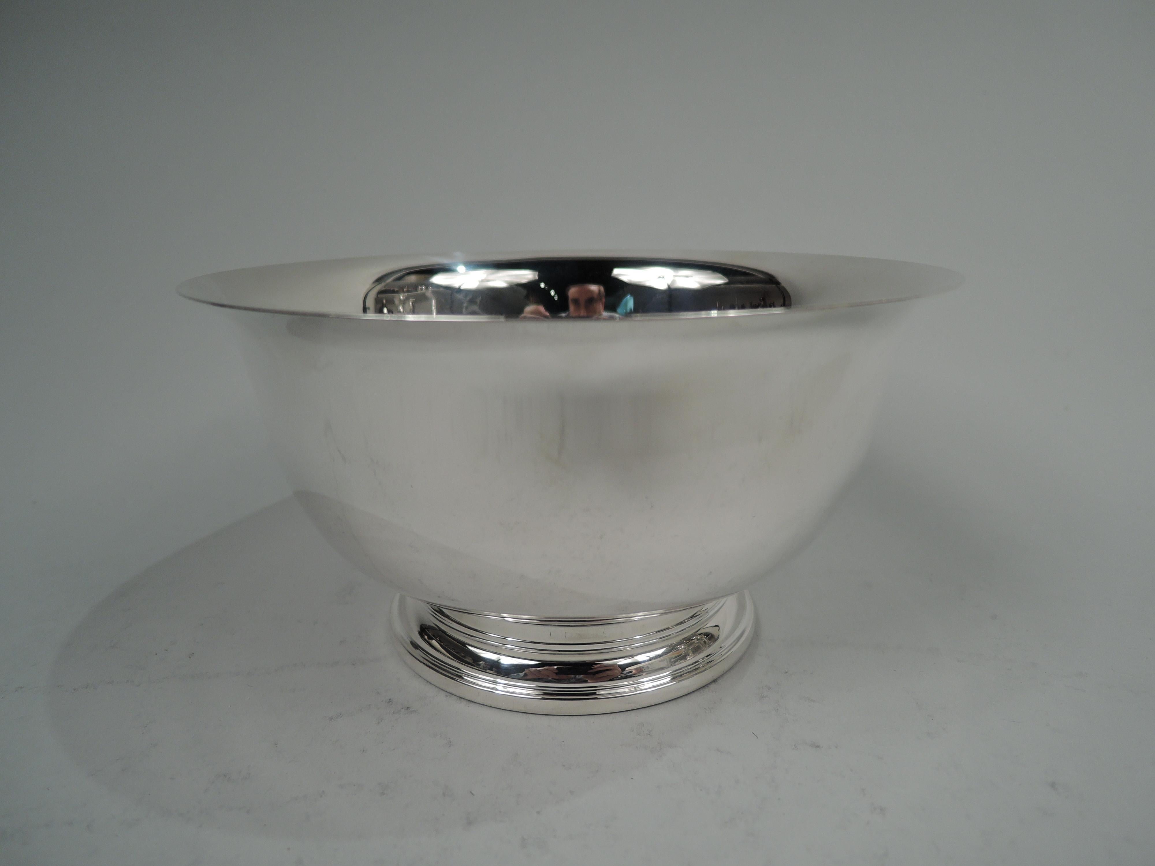 Traditional sterling silver Revere bowl. Retailed by Cartier in New York. Tapering sides with flared rim and curved bottom; stepped foot. Fully marked including retailer’s stamp, no. 9166, and phrase “A Paul Revere / Reproduction”. Weight: 7.3 troy