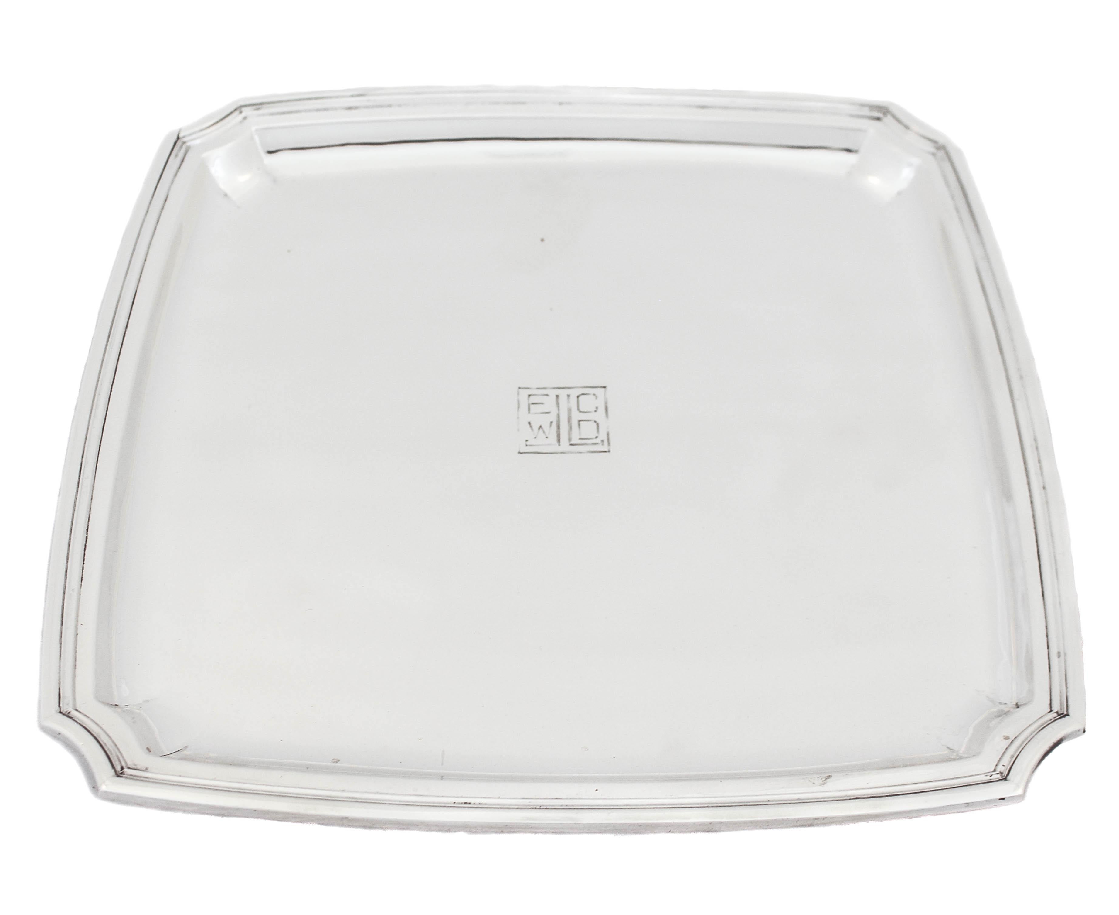 Being offered is a sterling silver tray by the world famous Cartier. It’s Mid-Century classic shape and style is sophisticated and elegant. The corners are scalloped and there is are ridges along the rim. In the center a hand engraved monogram