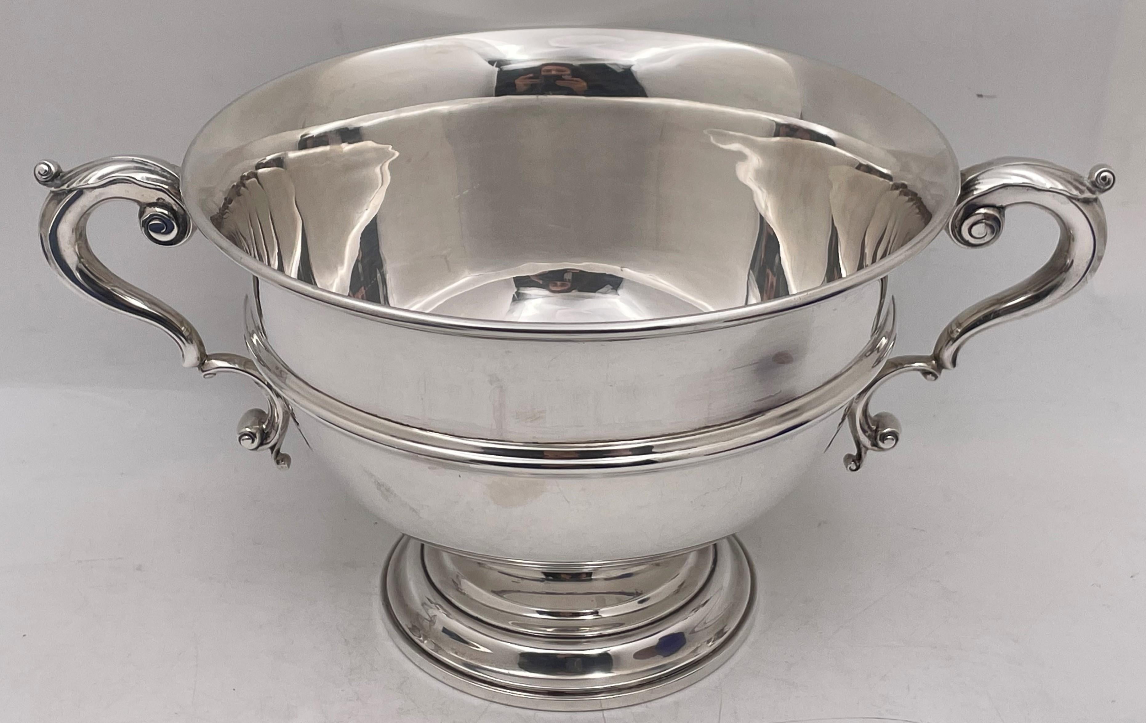 Cartier sterling silver two-handled centerpiece bowl or trophy with an elegant, geometric design. It measures 12 3/4'' from handle to handle (bowl diameter is 8 3/4'') by 6 1/8'' in height, weighs 32.1 troy ounces, and bears hallmarks and a monogram