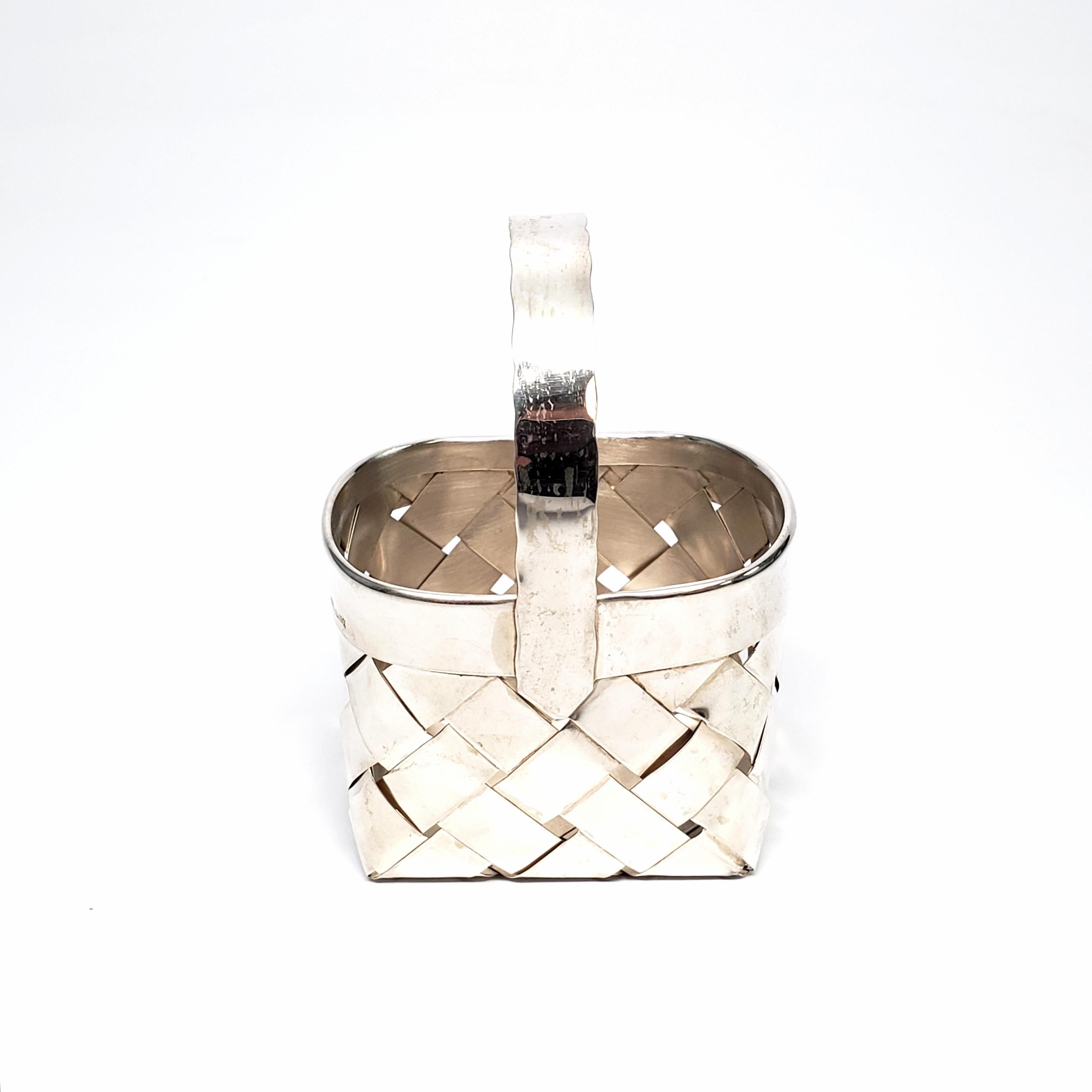 Vintage sterling silver basket from Cartier.

This retired piece is beautifully handcrafted from woven sterling silver strips.

Basket measures approx 2 3/8
