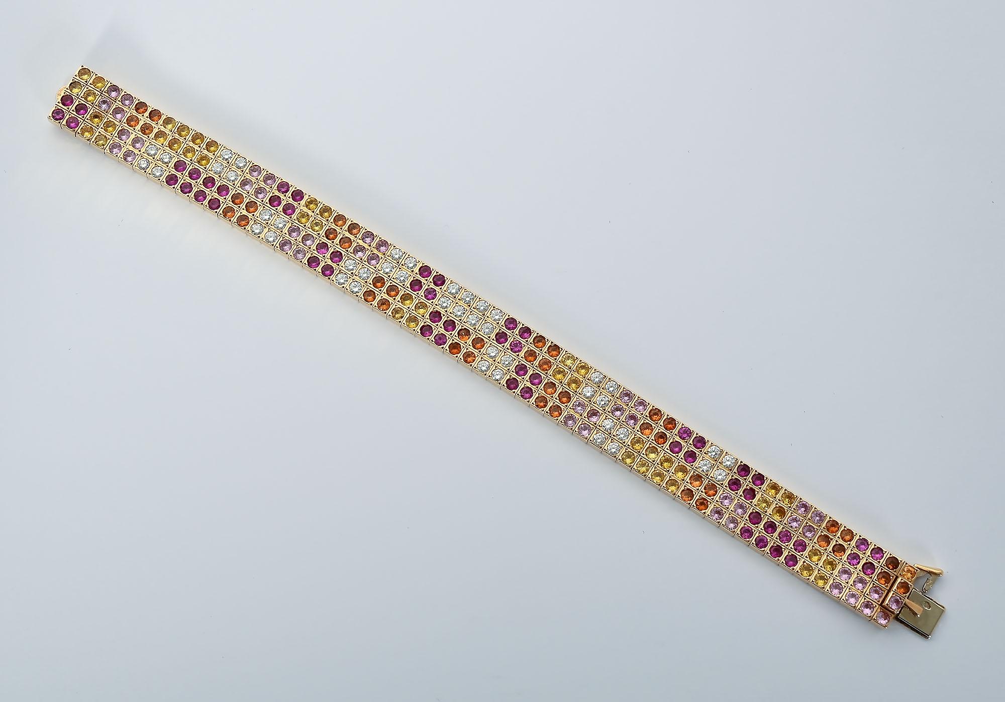 Exquisite Cartier strap bracelet with diamonds and several colors of sapphires. It has 44 diamonds that weigh a total of 3.08 carats. Sapphires colored yellow; marigold and rose weigh a total of 20 carats. The bracelet is made in France. It has the 