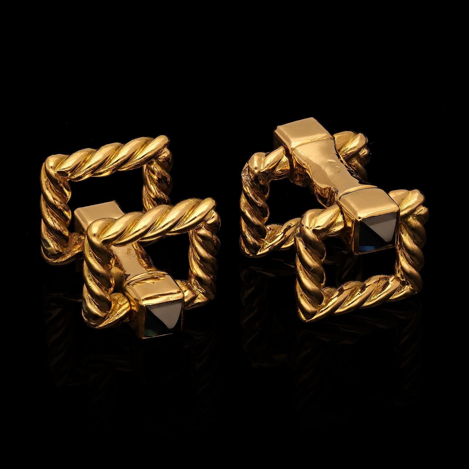 An elegant pair of French 18ct gold cufflinks by Cartier c.1950s, each double ended cufflink formed of a central solid bar terminated each end with a pyramid shaped blue sapphire within an open square shaped motif in rope twisted gold, both ends are