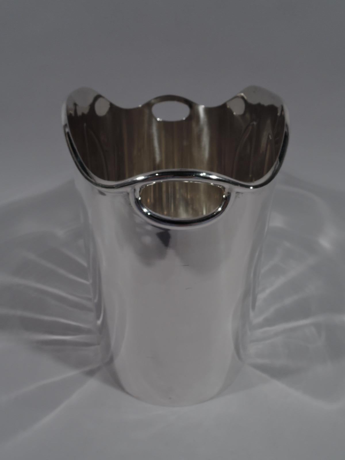 Super stylish sterling silver wine cooler. Retailed by Cartier in New York. Oval with straight sides, and molded and arched rim. Front and back have embossed vertical geometric ornament. Cutout oval side handles. Post-1967 Italian hallmark with