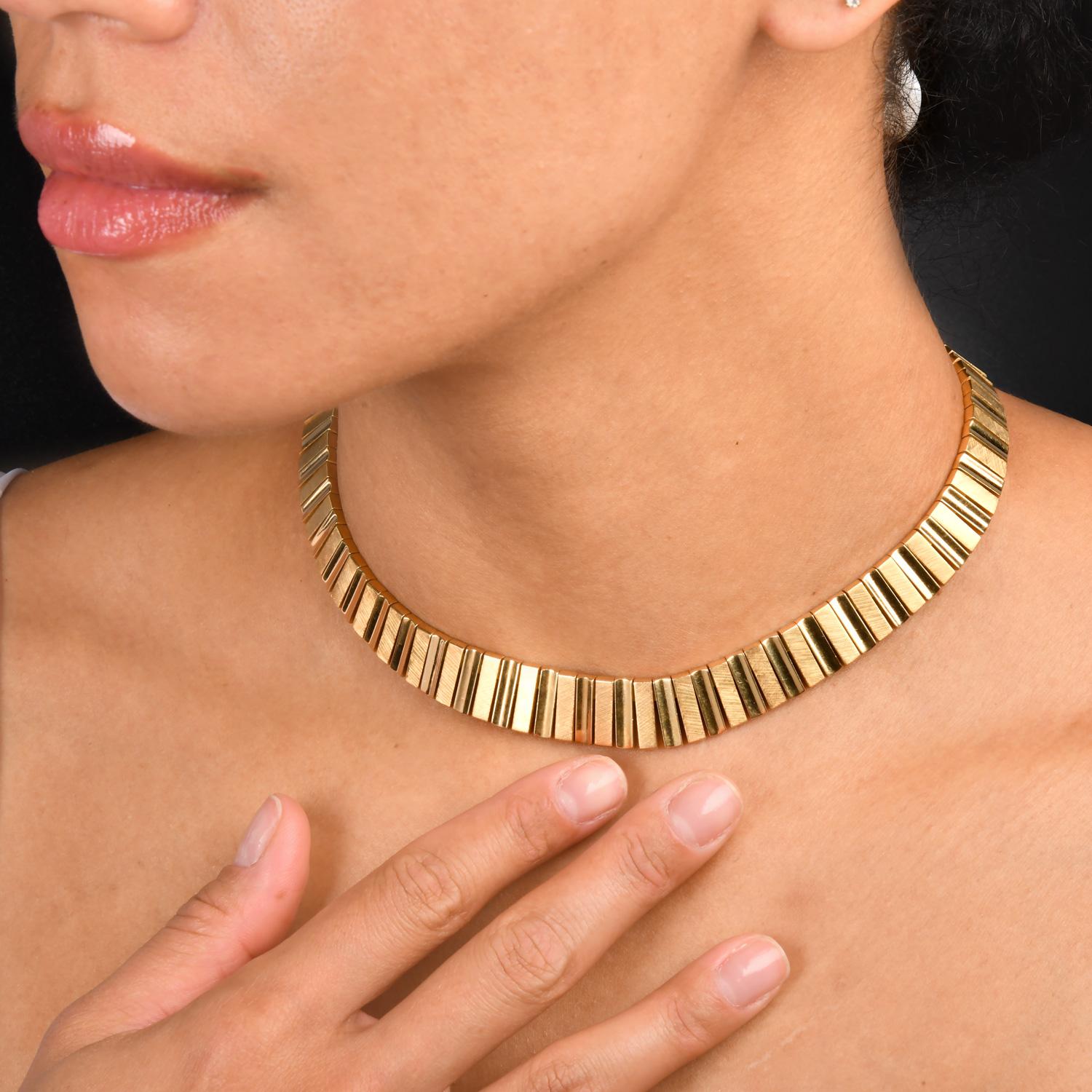 This Stunning 1970s Cartier Choker Necklace was inspired by a Cleopatra motif and crafted in 18K Yellow Gold.

Measuring appx. 1/2 Inch wide,  and 16 inches long. The links are textured with a Satin finish.

Weighing appx. 104.2  grams, this choker