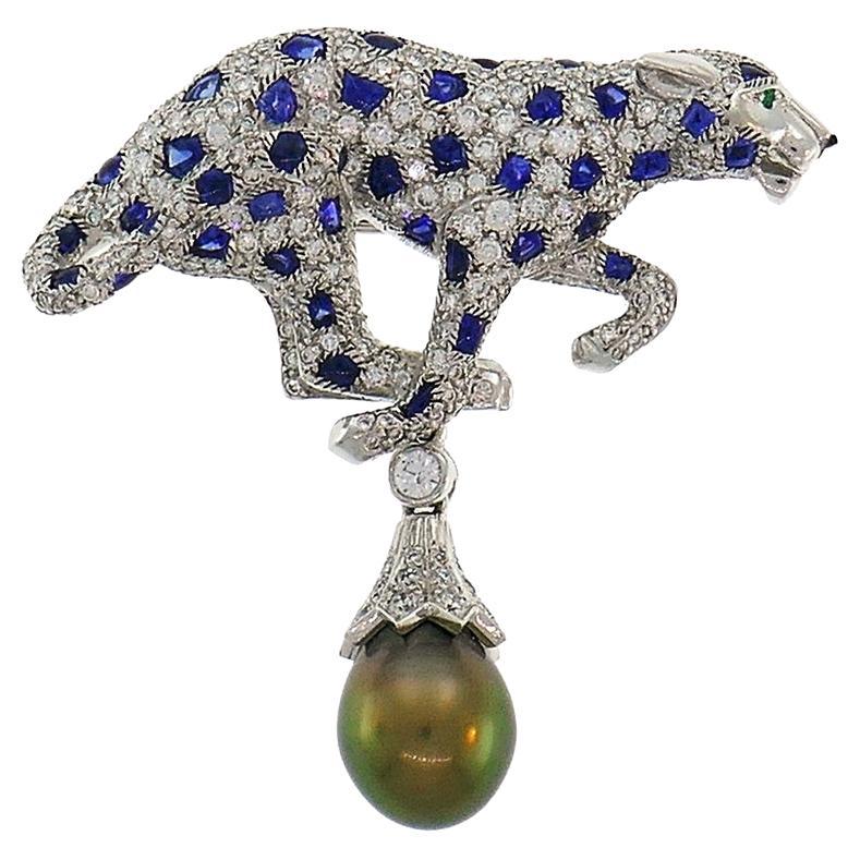 Iconic Cartier Panthere design. 

Made of platinum, the pendant features a beautiful Tahitian grey pearl. 

The panthere is encrusted with round brilliant cut diamonds (F-G color, VS1 clarity, 1.75 carats total) and blue sapphires (1.91 carats