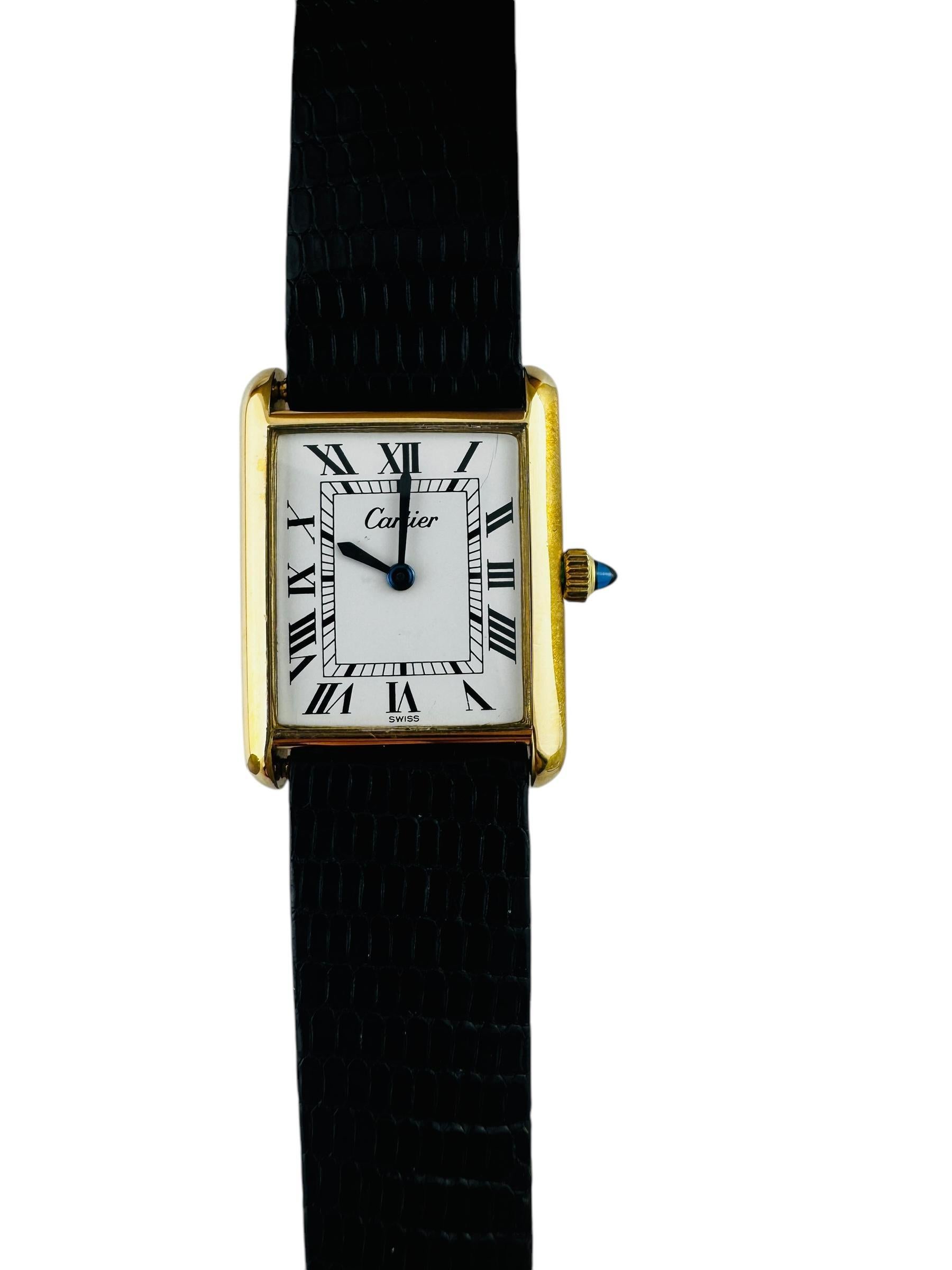 Cartier Tank Watch

This classic Cartier tank watch set in 18K electroplated yellow gold.

Watch case is approx. 30 mm in length and 23 mm wide. 6 mm thick

White dial with black Roman numeral markers

Cabochon blue sapphire crown

Hand winding