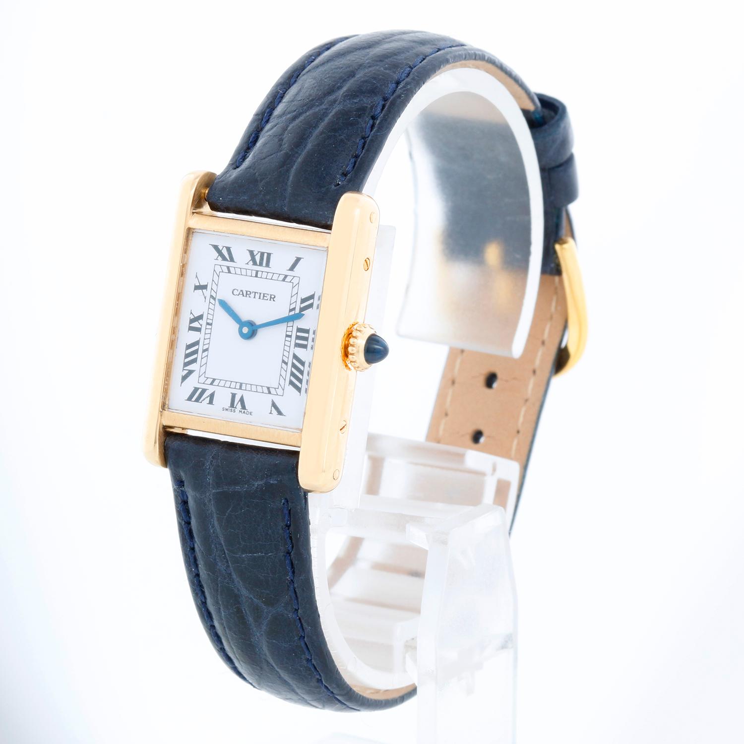 Cartier Tank 18K Yellow Ladies Watch  - Manual winding . 18k yellow gold case with stainless steel back (20mm x 28mm). White dial with black Roman numerals. Blue alligator strap with tang buckle . Pre-owned with custom box.