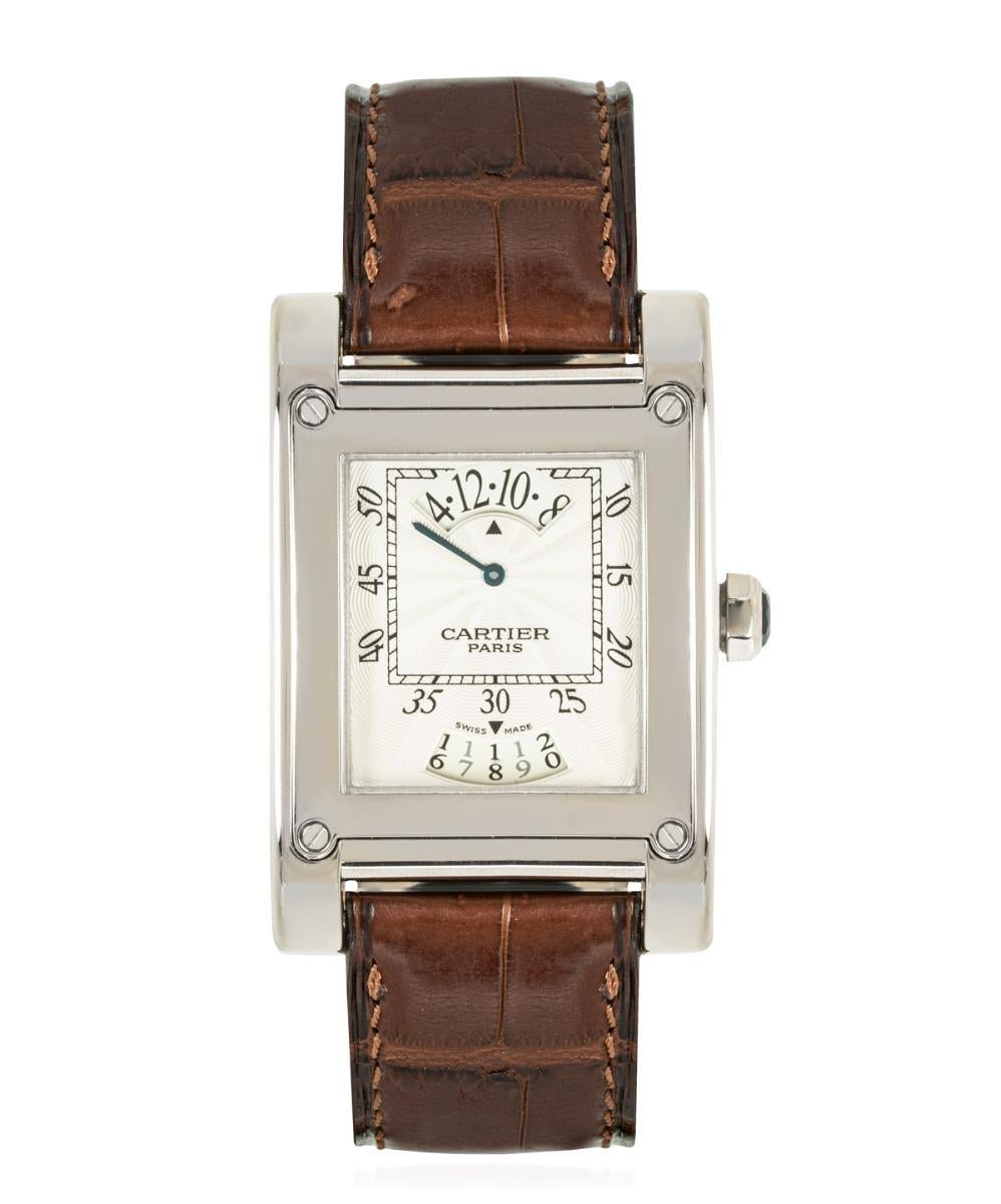 A stunning 28mm white-gold Tank À Vis part of the Collection Privée Cartier Paris (CPCP).

Features a silver guilloche dial with a wandering hours complication, a date display and a white gold bezel. The watch is presented on a Cartier brown leather