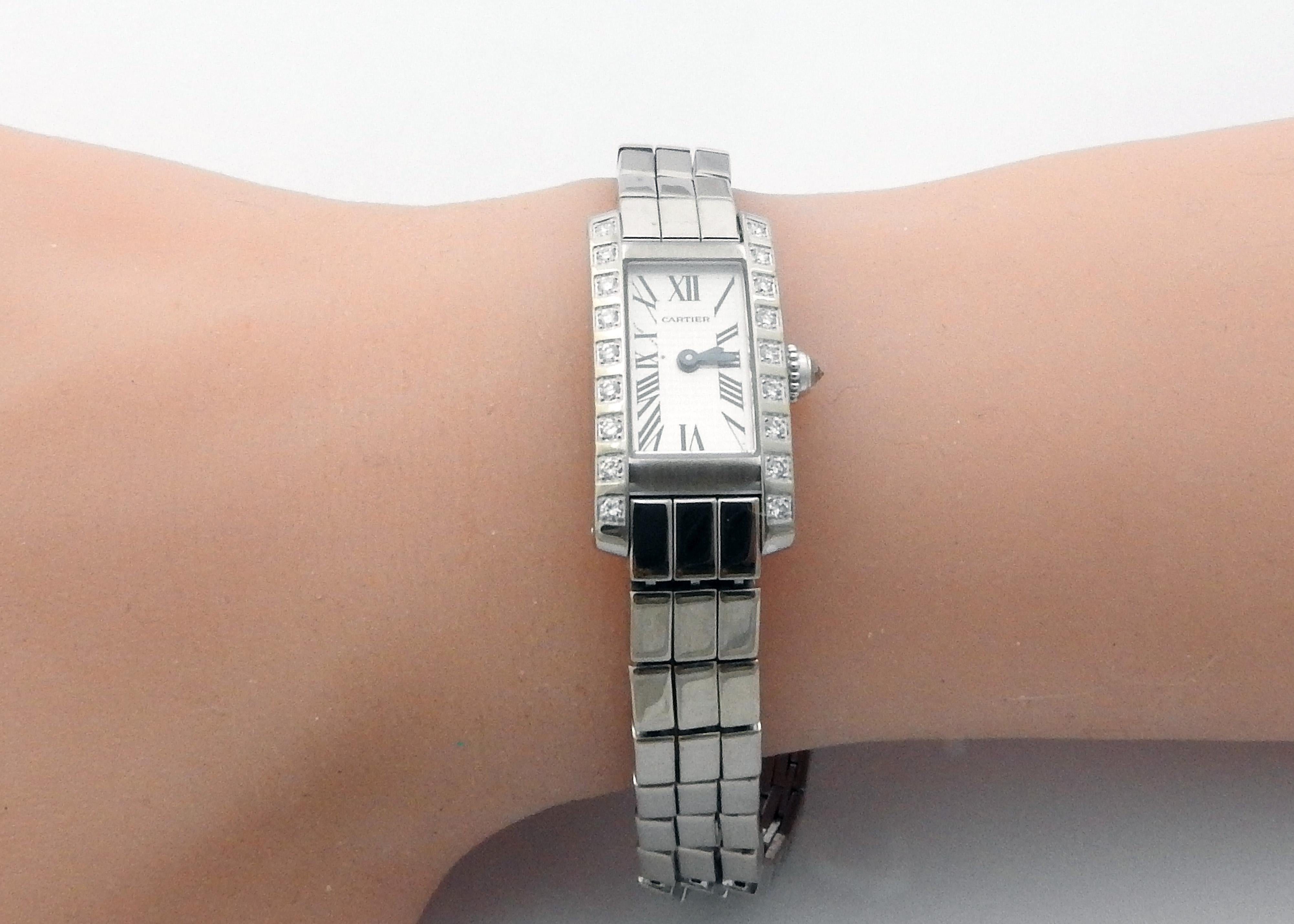 Cartier Tank Allongee Lanieres 18K White Gold and Diamond Ladies Watch

Model: W15364W3 / 2544
Serial: 13930CE

This authentic Cartier Tank watch is set in 18K white gold

Bezel is set with 18 round brilliant diamonds. 

Crown is set with one round
