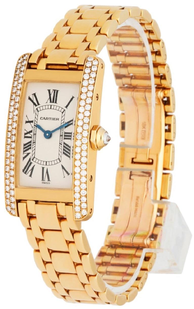 
Cartier Tank Americaine 1710 Ladies Watch. 19MM 18K yellow gold case. 18K yellow gold bezel with factory diamond set. Off-white dial with blue hands and black Roman numeral hour marker. 18K Yellow gold bracelet with hidden butterfly clasp. Will fit