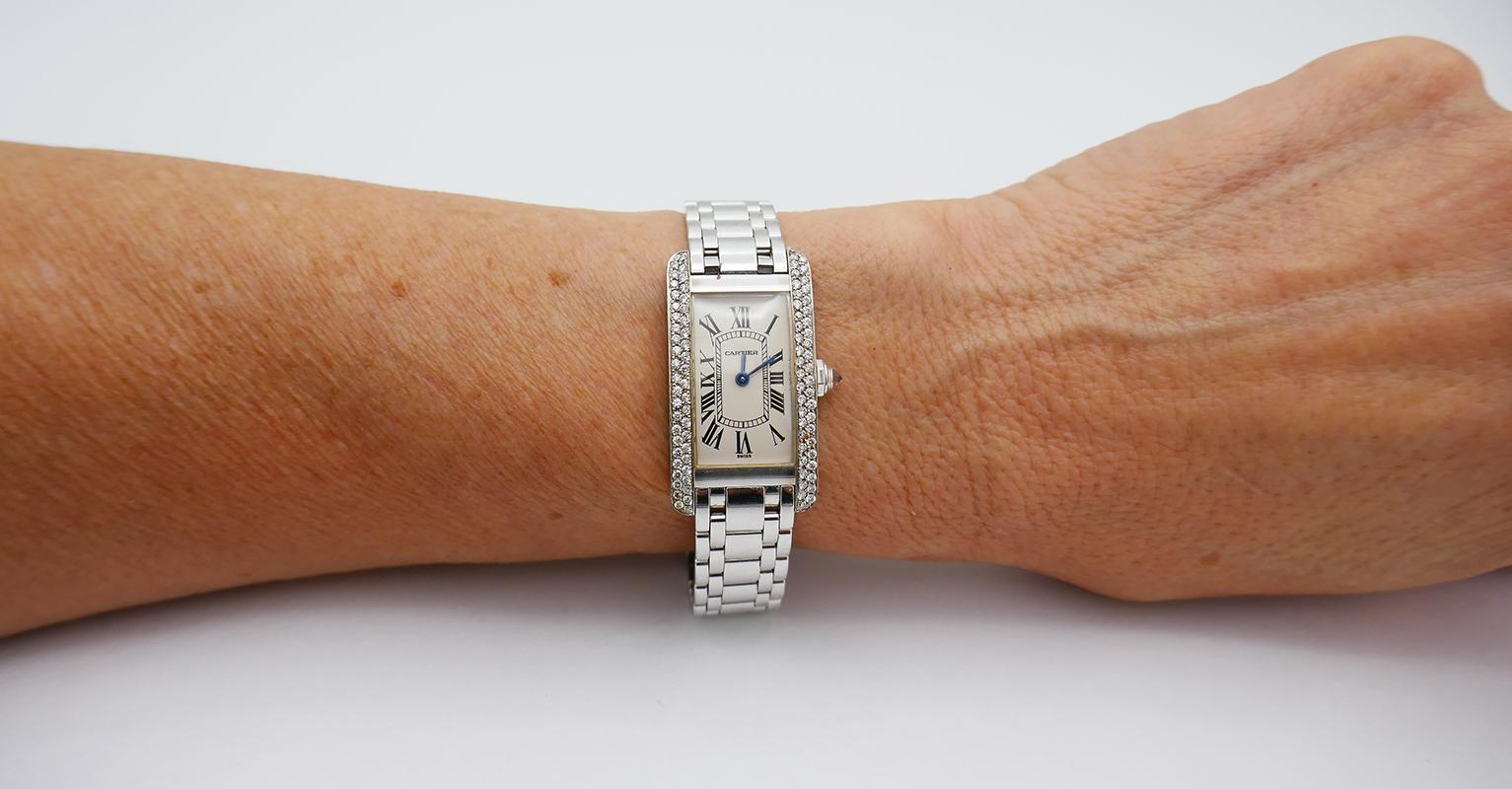 A vintage Cartier Tank Américaine watch made of 18k white gold with two rows of diamonds on the sides.
The Tank model is an iconic classic watch by Cartier designed in 1917. The look of the watch was inspired by the Renault FT-14, a French tank used
