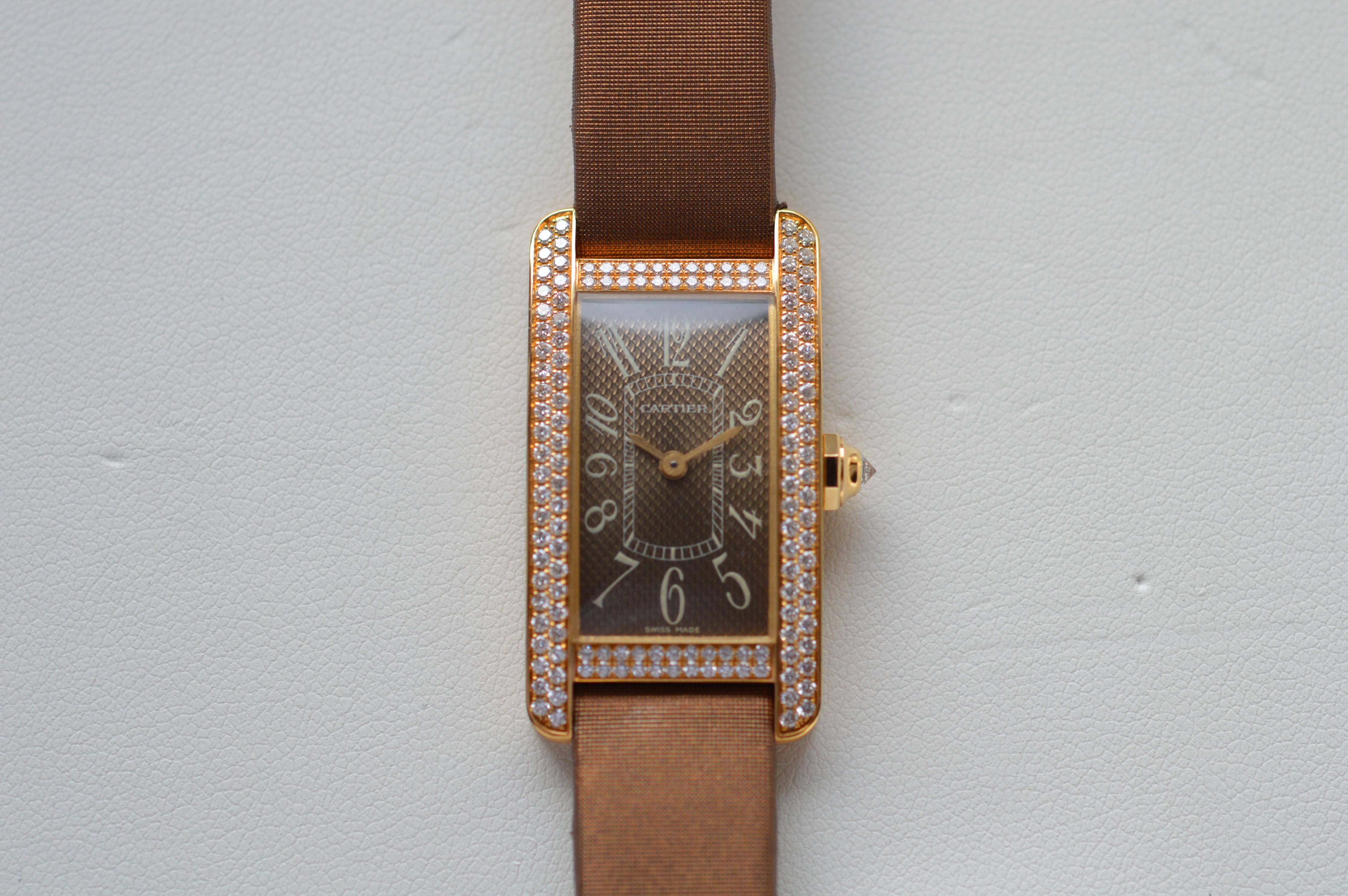 Cartier Tank Americaine PM 18K Yellow Gold on Satin Strap with Diamond Bezel
Reference n° WB704331
PM (Petit Model) size
35 X 19mm
18K Yellow Gold Case
Brown Satin Strap
White Diamond Crown
Brown Dial
Water-Resistant
Qartz Movement
143 Top Wesselton