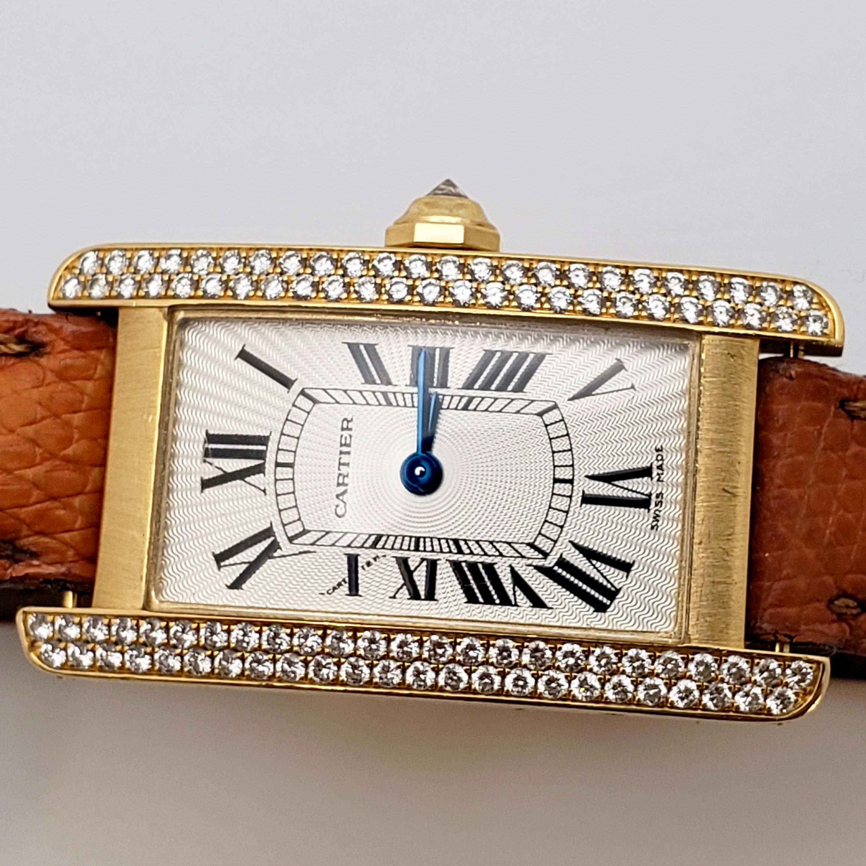 An authentic 18K yellow gold Cartier Tank Americane watch (model #: 2482) with an original diamond bezel. Mounted with 98 round brilliant cut diamonds weighing a total of approximately 1.00 CT. This beautiful watch features quartz movement and a