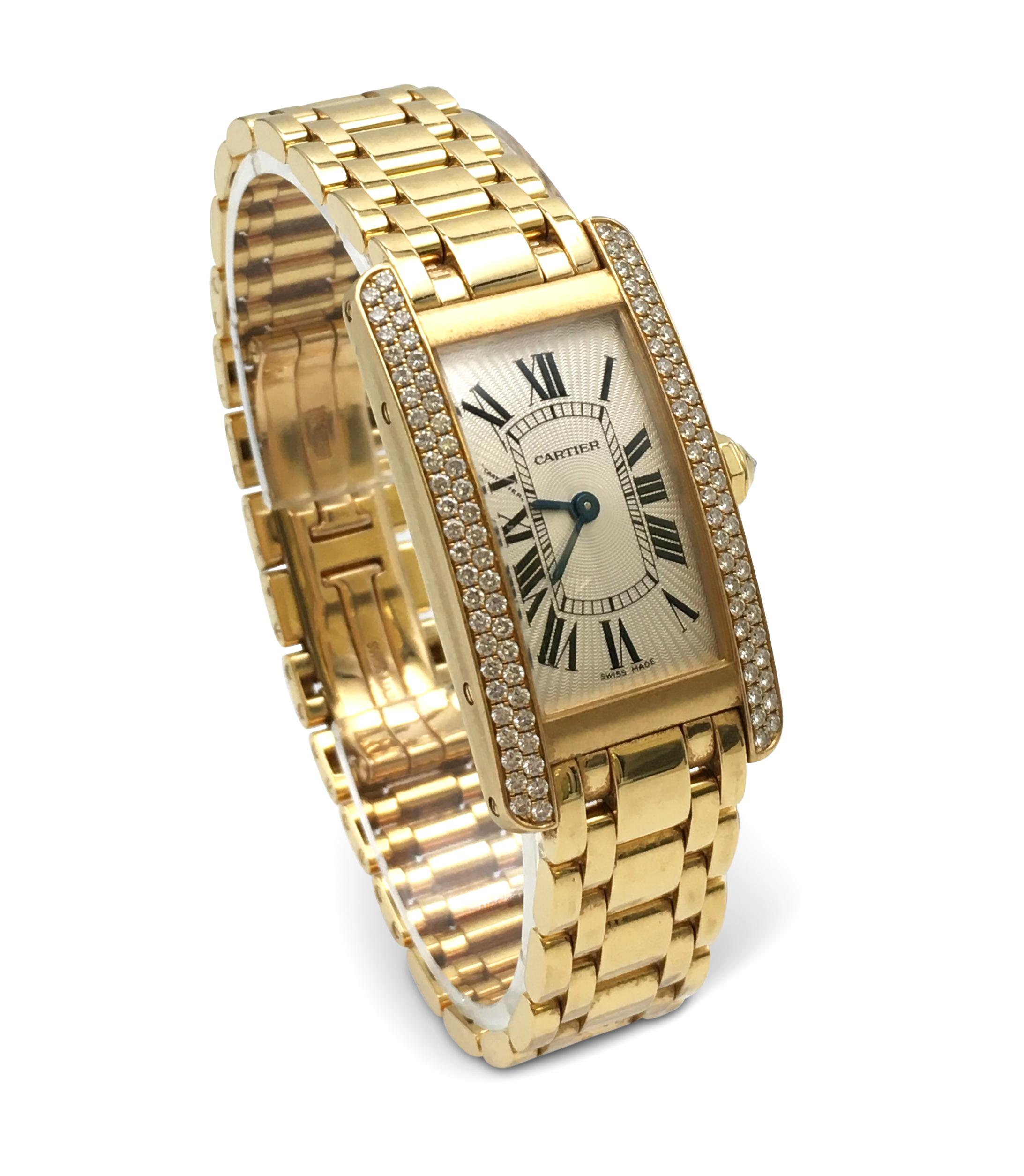 Authentic Cartier Tank Americaine wristwatch made in 18 karat yellow gold with approximately 99 round cut diamonds.  The case measures 19 x 34mm and is set with 4 screws, sapphire crystal. CIRCA 2010's.  The watch is accompanied by its original