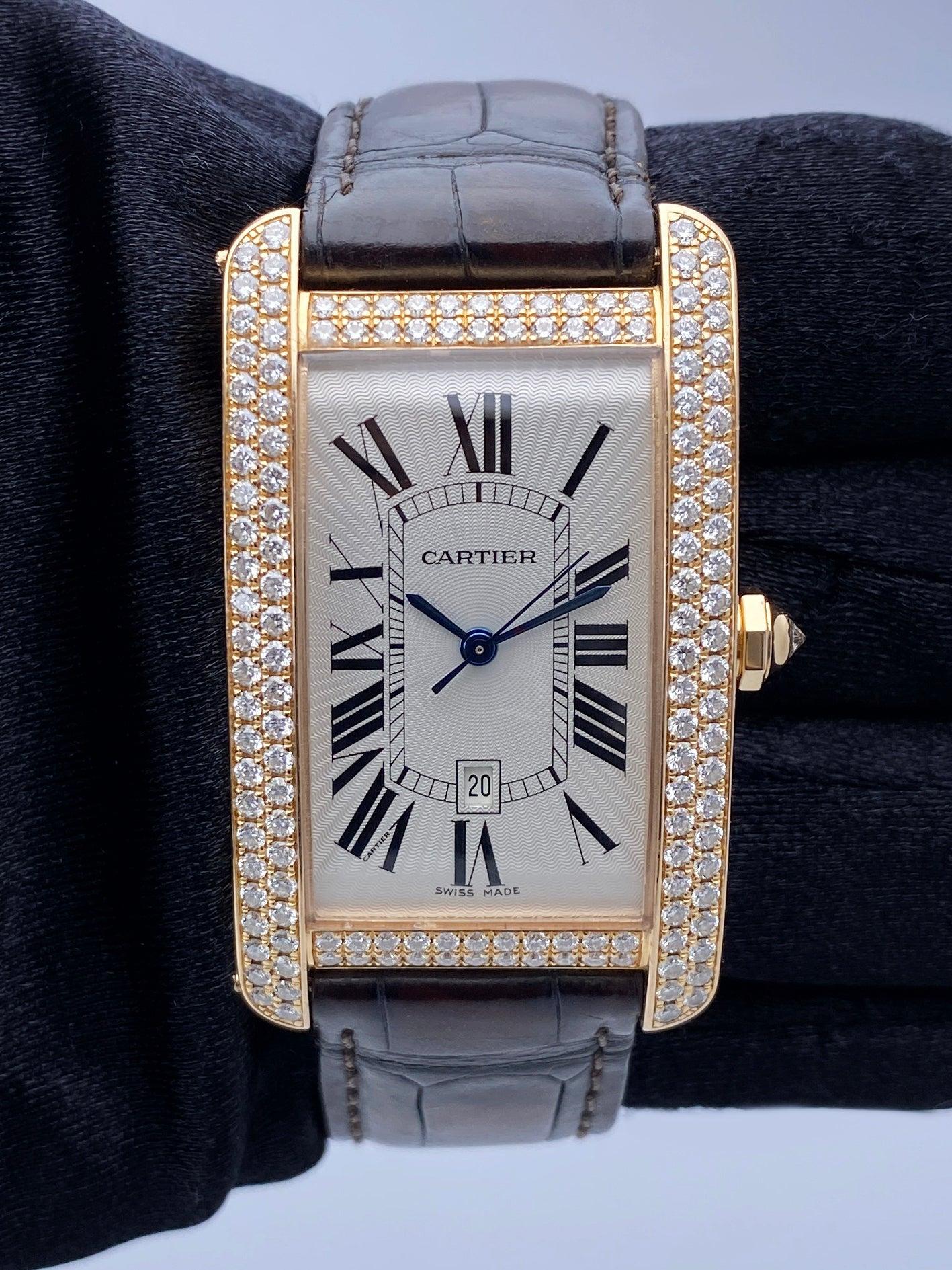 Cartier Tank Americaine WB704851 / 2505 Watch. 27mm 18K rose gold case with factory diamond set. Silver dial with blue hands and black Roman numeral hour marker. Date display at 6 o'clock. Brown leather strap with 18K rose gold deployment clasp.
