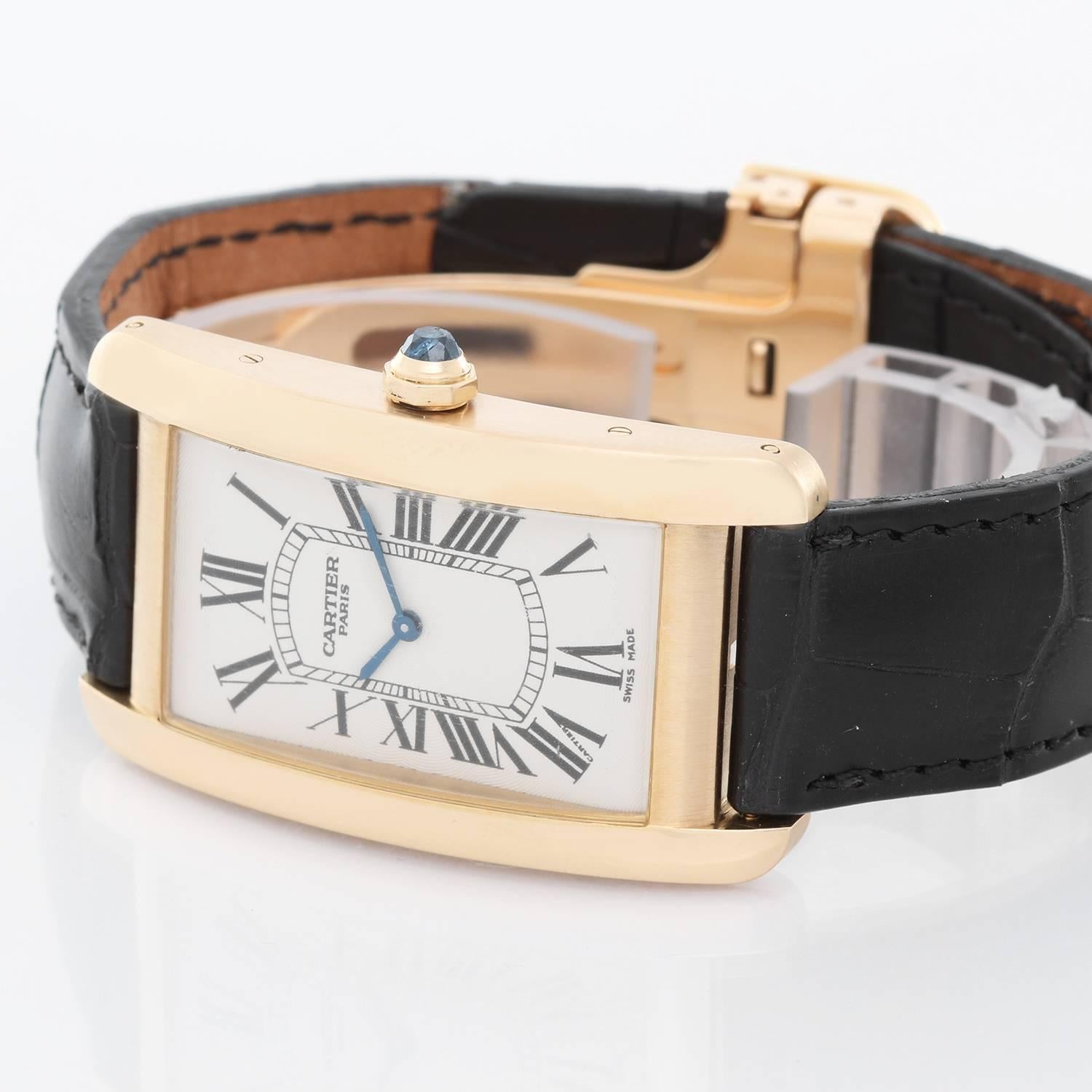 Cartier Tank Americaine (or American) Large  Men's Gold Watch -  Manual winding. 18k yellow gold rectangular style case (45 mm x 27 mm). Silvered dial with black Roman numerals. Strap band with 18k yellow gold Cartier buckle. Pre-owned with  box.