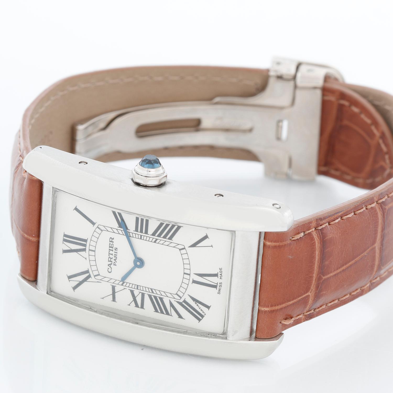 Cartier Tank Americaine (or American) Large  Men's Platinum Watch Ref 1734 - Manual winding. Platinum rectangular style case (44 mm x 27 mm). Silver dial with black Roman numerals. Strap band with 18k white gold Cartier deployant buckle. Pre-owned