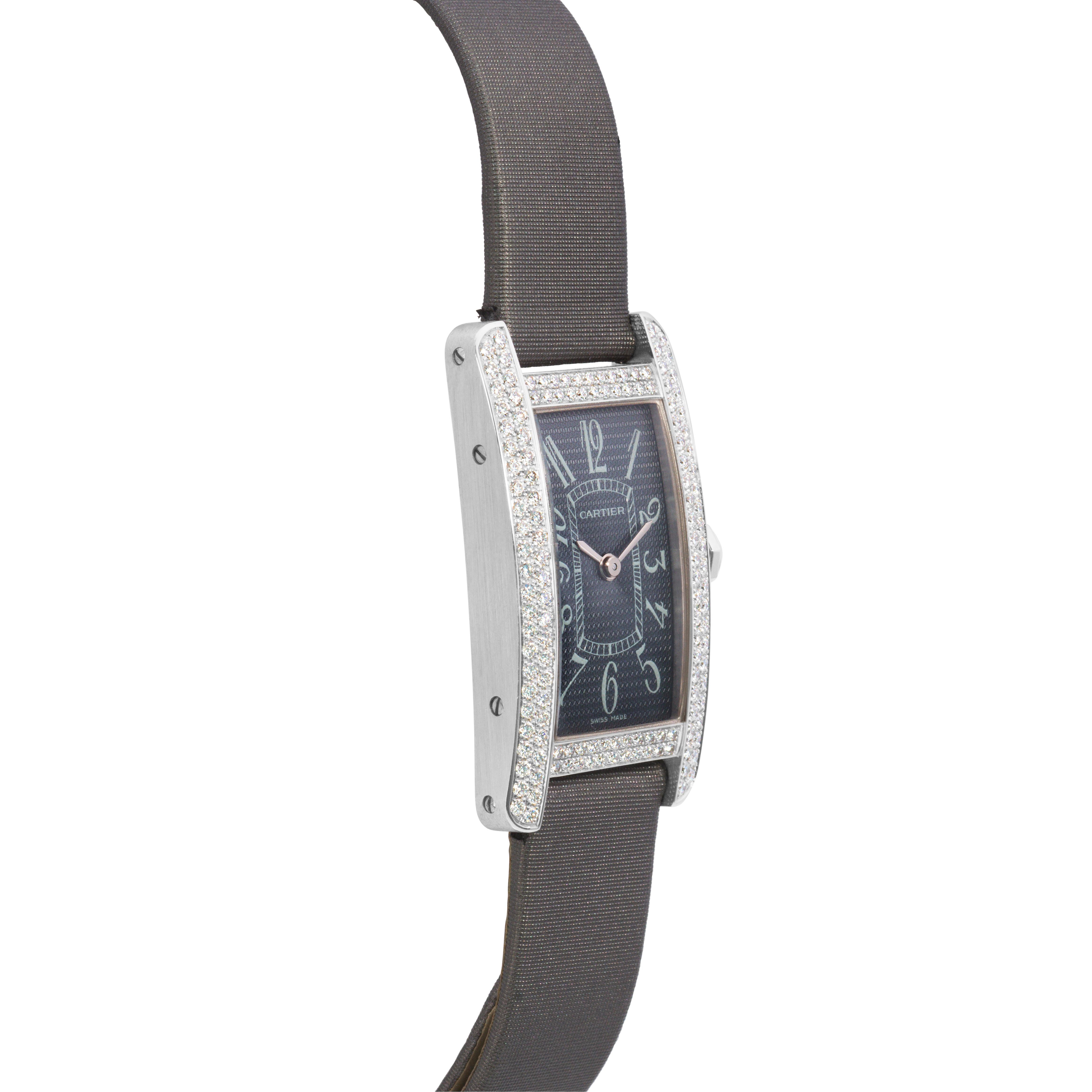 A magnificent wristwatch created by Cartier from the Tank Americaine collection, featuring a diamond encrusted bezel and a crown accented by a diamond. Finely made with 18K white gold and dark gray straps. 

Quartz movement
35mm by 19mm 
Reference