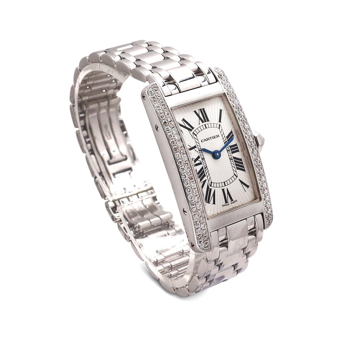 Authentic Cartier Tank Ameriçaine watch crafted in 18 karat white gold.  34.8mm x 19mm case with diamond bezel and diamond crown, Swiss Quartz movement, silver guilloche dial, blue steel sword-shaped hands, and 18 karat white gold bracelet.  Wrist