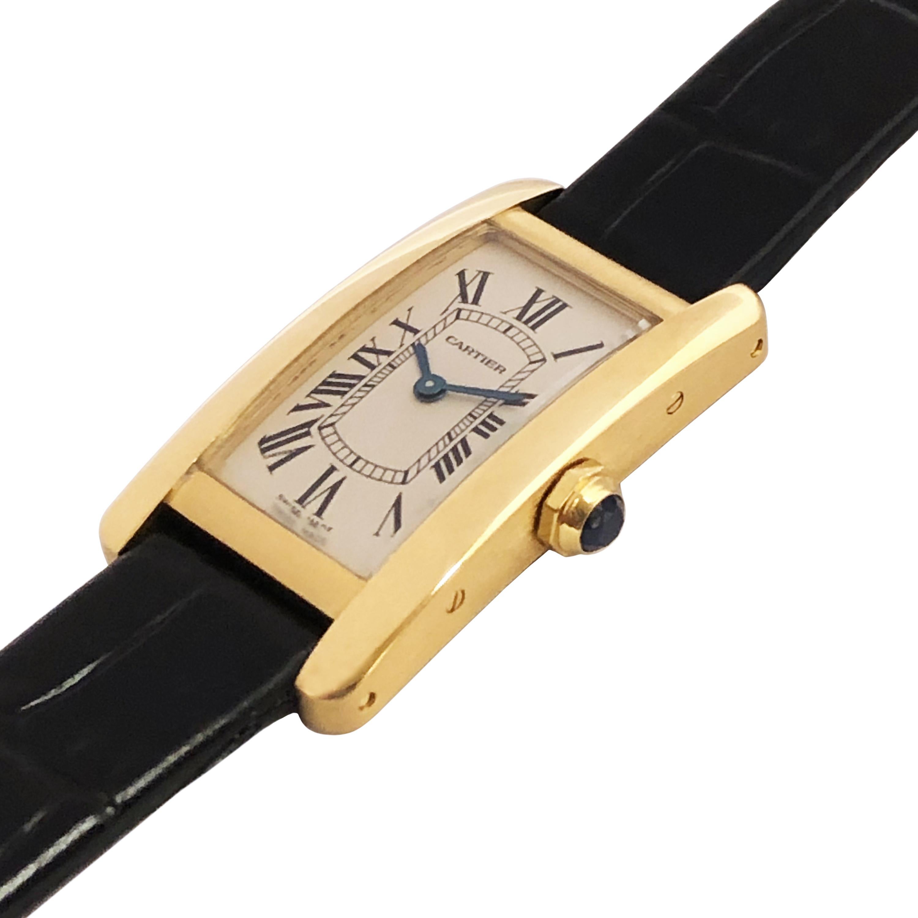 Circa 2000 Cartier Tank American ladies wrist watch, 34 X 19 MM 18K Yellow Gold water resistant case. Quartz Movement, White dial with Black Roman Numerals, Sapphire Crown. New Hadley Roma Black textured leather strap with original Cartier Yellow