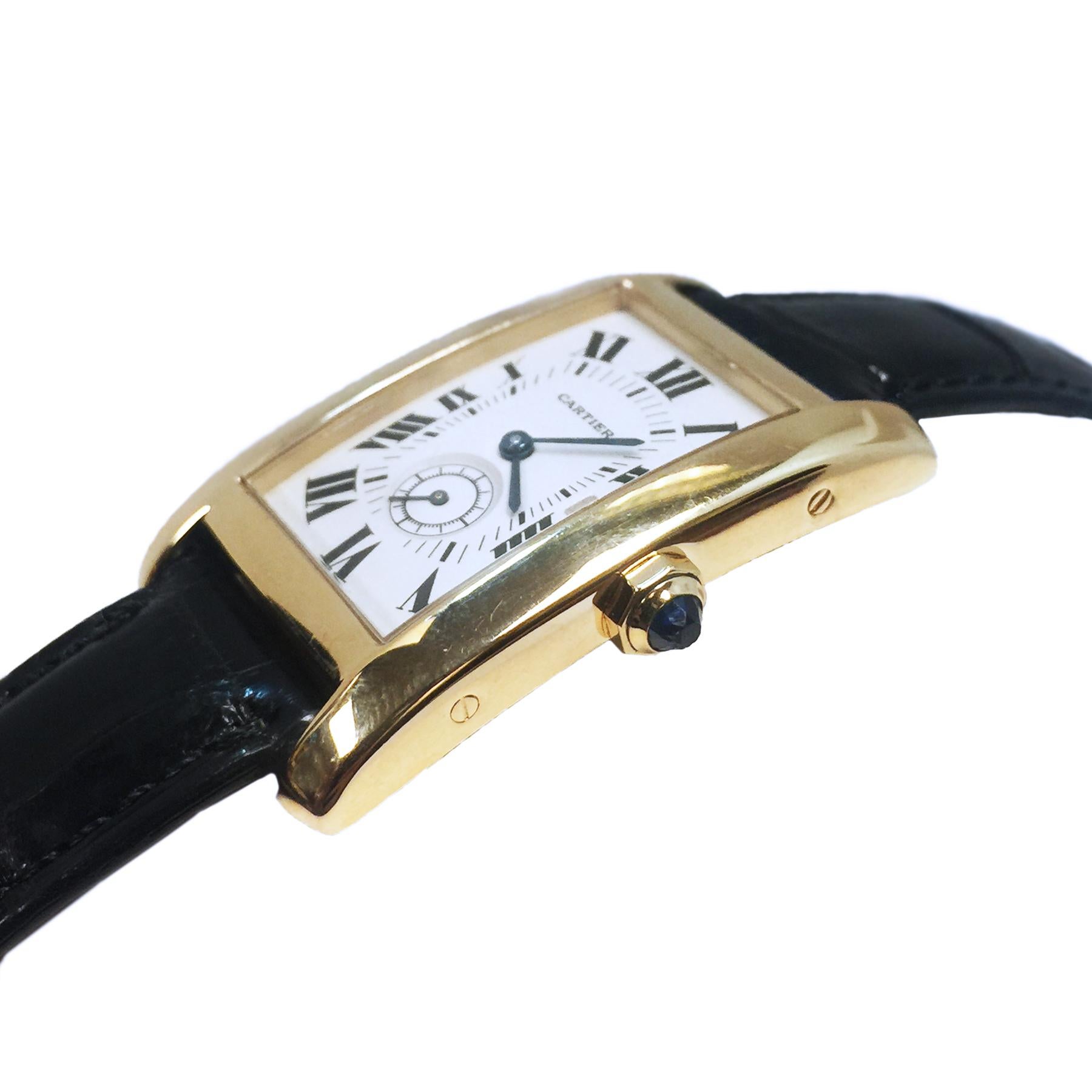 Circa 2000 Cartier Tank American Wrist Watch 41 X 24 MM 18K Yellow Gold Water resistant Case, Quartz movement, white dial with Black Roman numerals and a sub seconds dial, scratch resistant crystal and a Sapphire crown. Black Cartier Alligator Strap