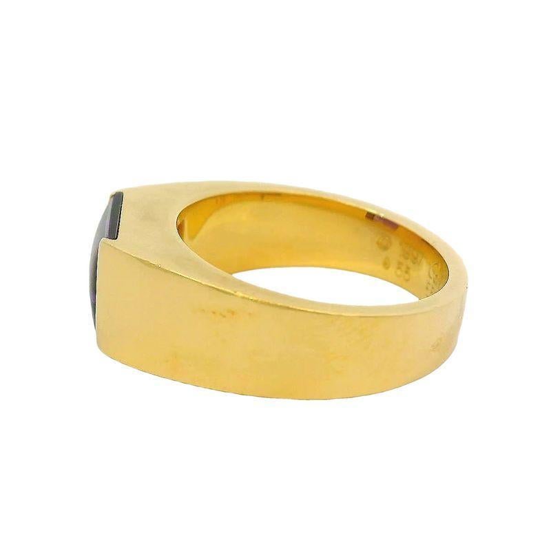 This Cartier band ring is crafted in 18k gold and features a vibrant amethyst at its center. Weighing 12.15 grams. Ring Size 7-1/4. Cartier size 55.
