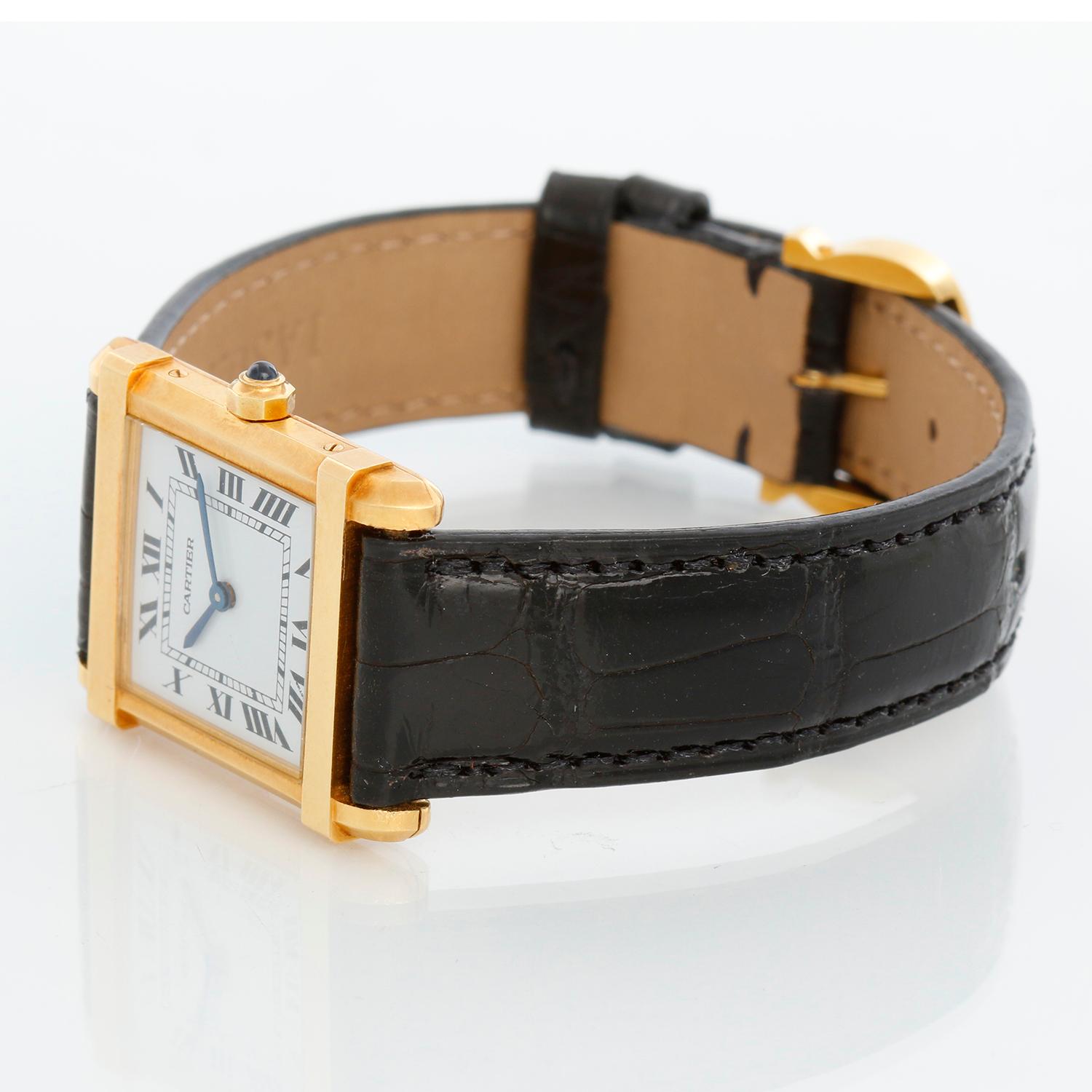 Cartier Tank Chinoise 18K Yellow Gold Men's Watch - Quartz. 18k yellow gold case ( 23 mm x 30 mm ). White dial with black Roman numerals. Black Cartier strap band with 18k yellow gold Cartier buckle. Pre-owned Unpolished with Cariter box.