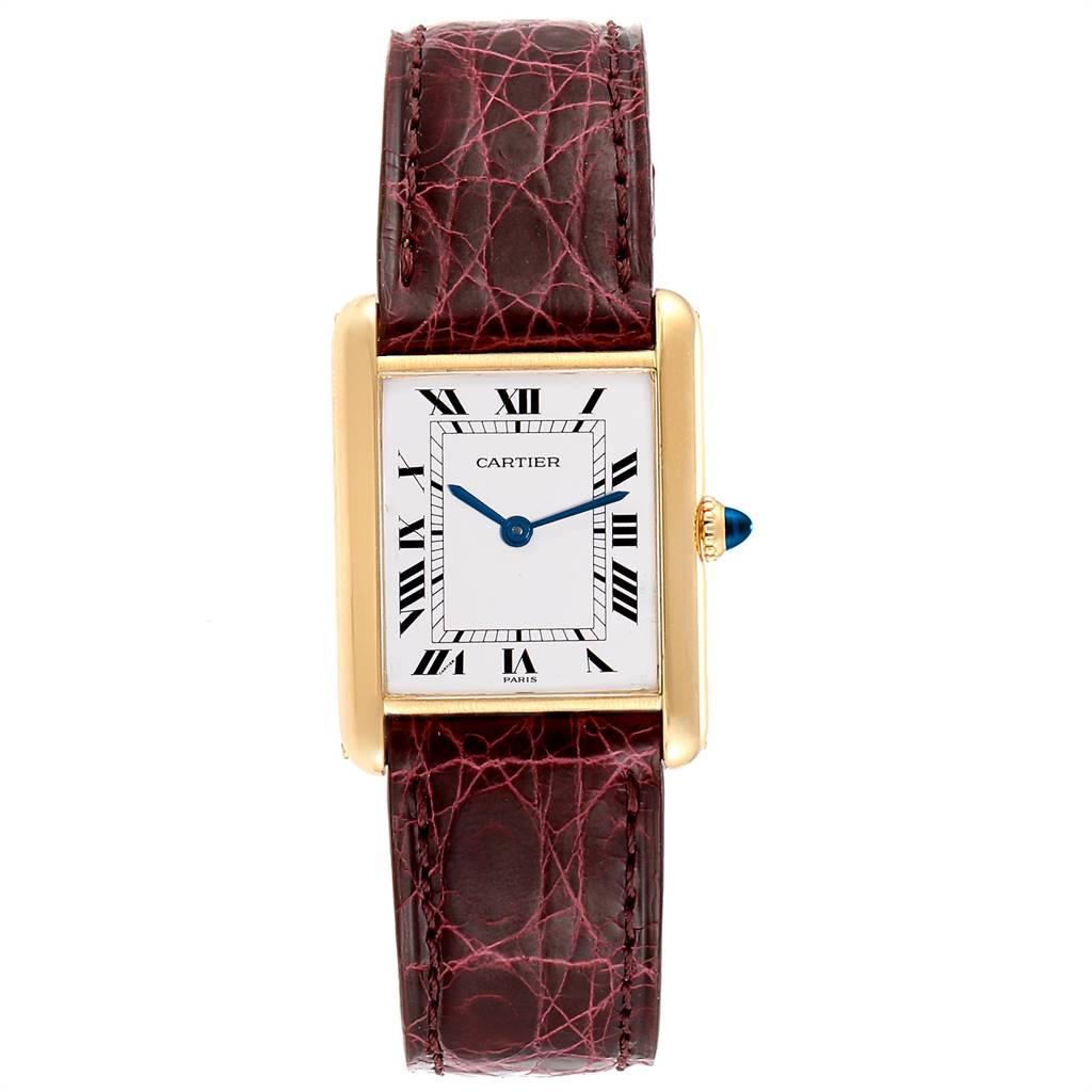 Cartier Tank Classic Paris 18k Yellow Gold Burgundy Strap Ladies Watch. Manual winding movement. 18k yellow gold case 22.5 x 30.5 mm. Circular grained crown set with the blue sapphire cabochon. Mineral glass crystal. White dial with black roman