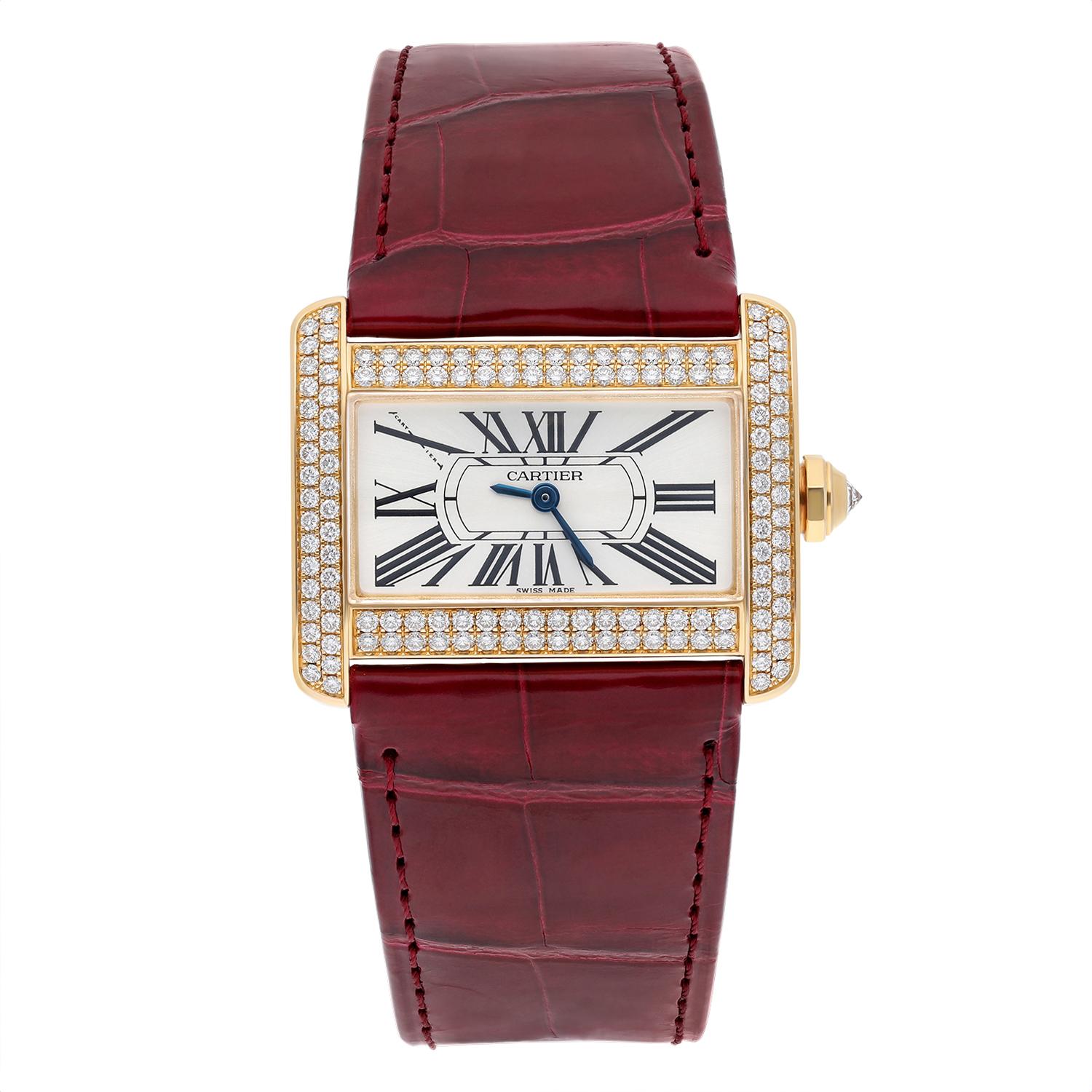 Elevate your style with this exquisite Cartier Tank Divan Mini wristwatch, crafted from yellow gold with a two-piece leather strap in a stunning red hue. The watch features roman numerals on a silver dial, with a factory diamond-encrusted bezel